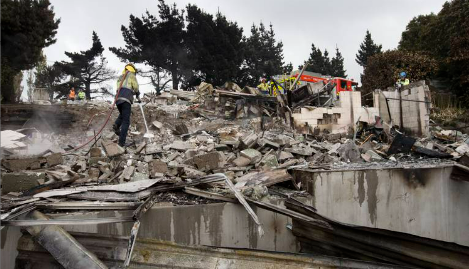 Firefighters dampening hotspots. Photo / Alan Gibson