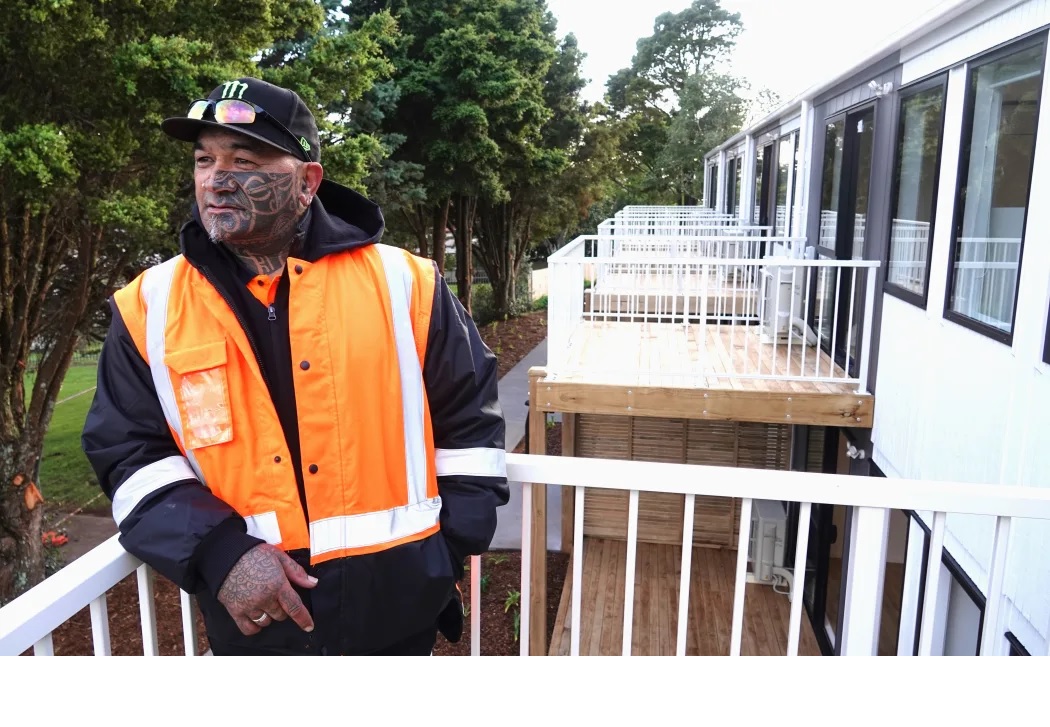 Anthony Tahere, who's expected to be one of the first tenants at Te Kohekohe, checks out the view from one of the first-floor units. Photo / Peter de Graaf