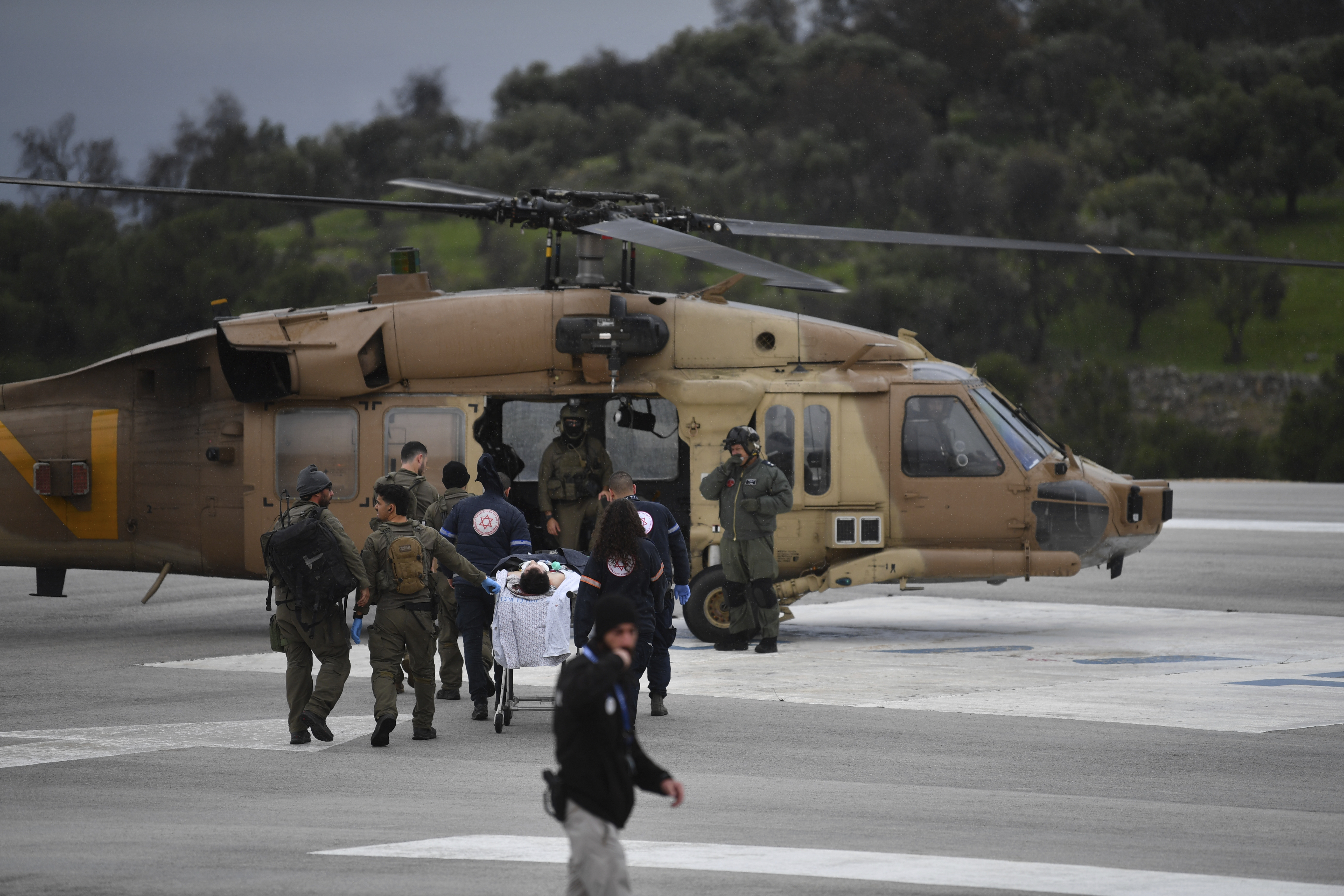An Israeli medical team evacuate a person injured by a rocket fired from Lebanon. Photo / AP