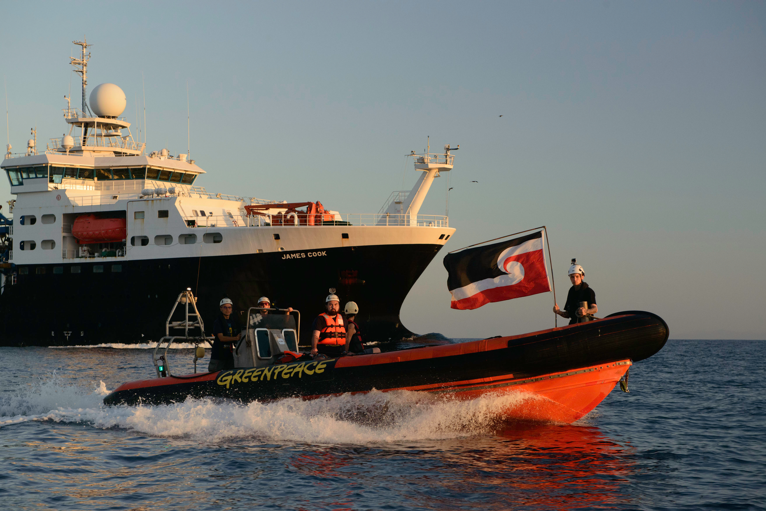 Greenpeace International activists peacefully confronted UK Royal Research Ship James Cook in the East Pacific. An activist scaled the side of the moving vessel to unfurl a banner reading “Say No to Deep Sea Mining”, while two Māori Indigenous activists swam in front of the ship, one holding the Māori flag and the other a flag reading “Don’t Mine the Moana”.
