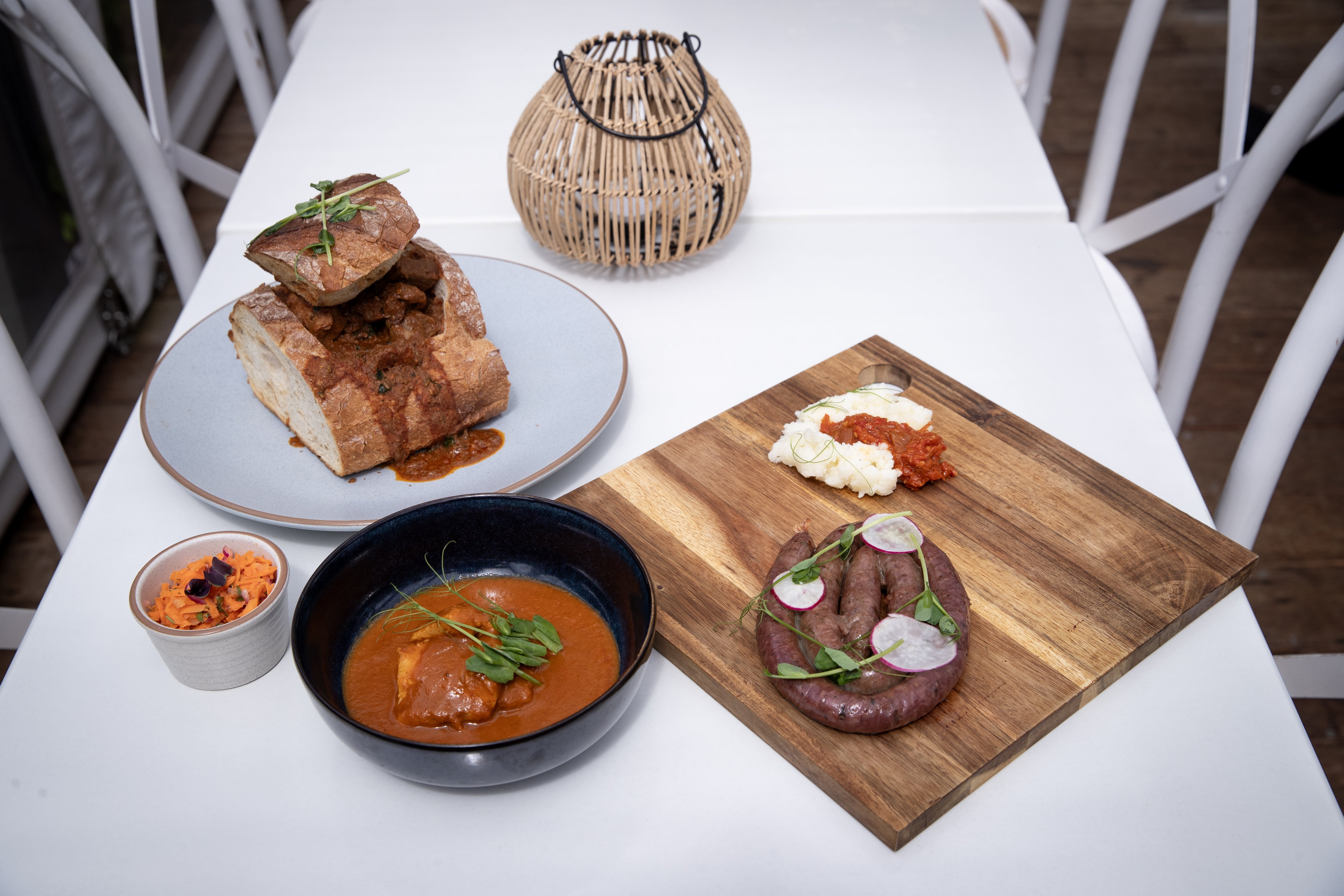 A selection of signature South African dishes including boerewors sausage with homemade chakalaka pap and Cape Malay fish curry from Okumnandi South African restaurant in Ponsonby. Photo / Dean Purcell