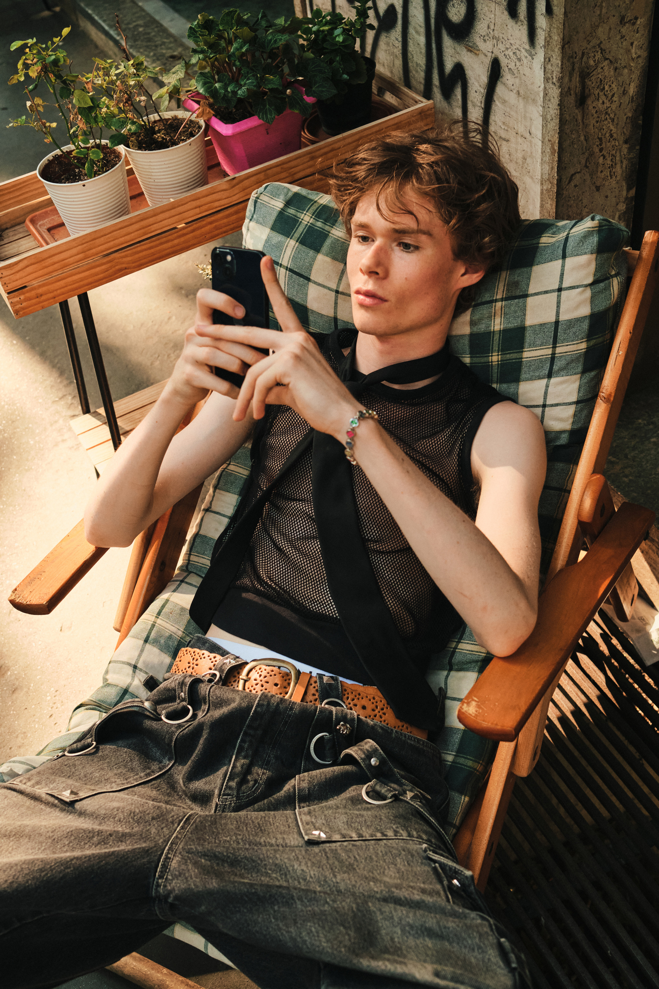 A mesh top styled with the black necktie, in Milan. Photo / Simbarashe Cha, The New York Times