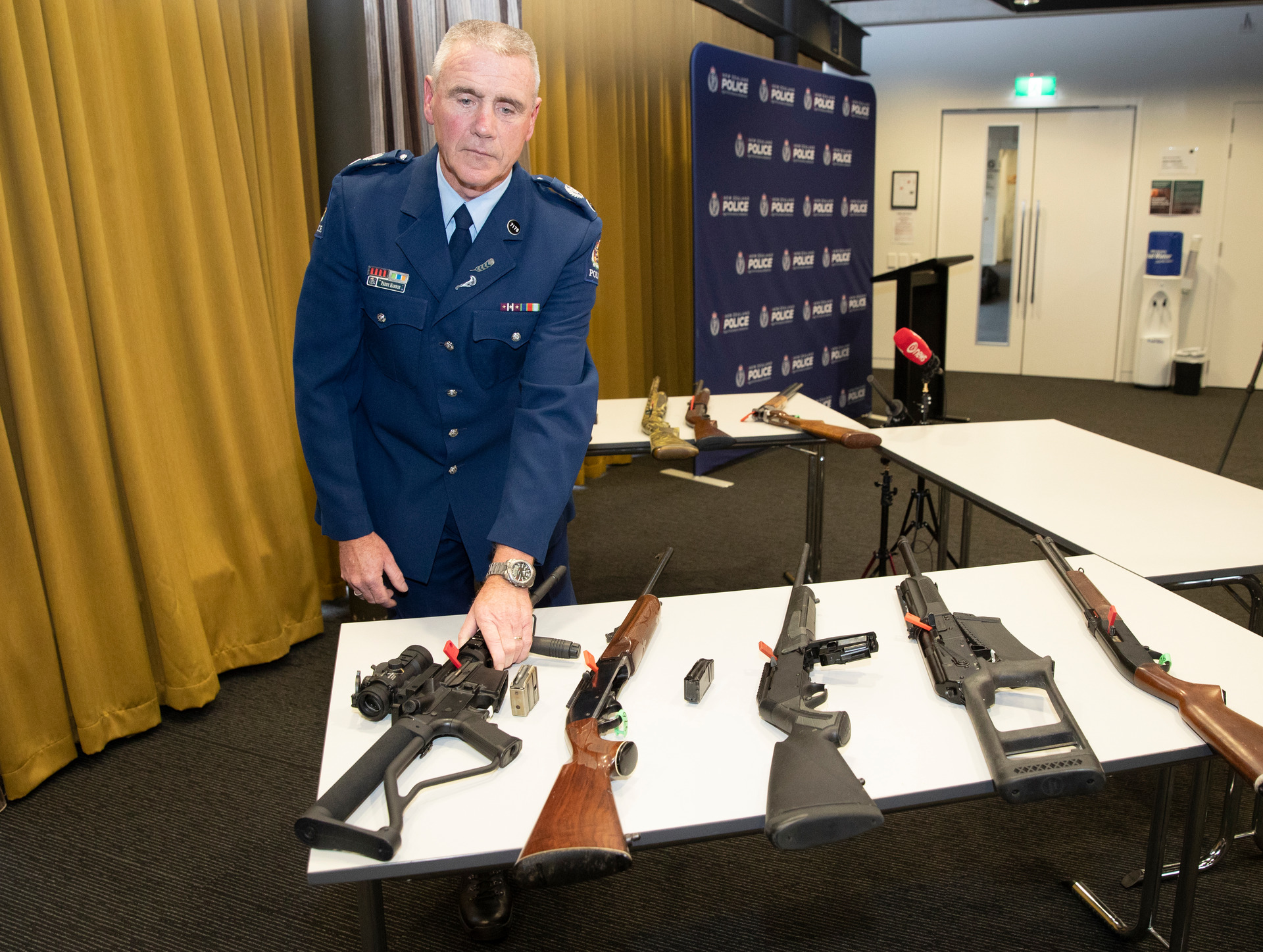 Police Senior Sergeant Paddy Hannon with weapons that are now illegal. Some members of the Council of Licenced Firearms Owners are reluctant to hand in their firearms. Photo / Mark Mitchell