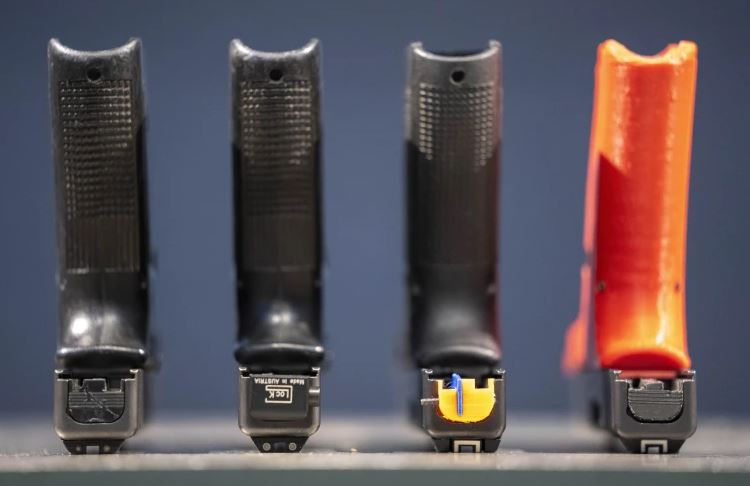 A row of semi-automatic pistols. Photo / AP