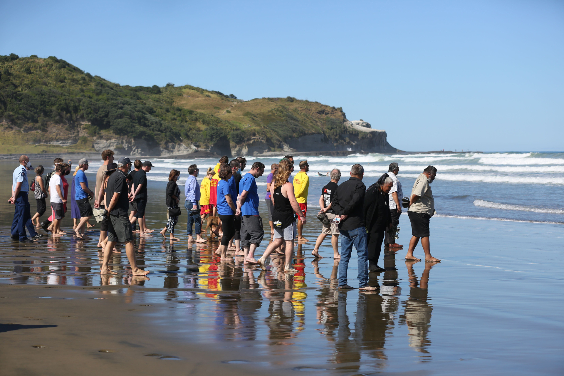 Friends of Sarah-Jane Bayram gather for a blessing at Muriwai Beach days after her death in a skydiving accident. Photo / Sylvie Whinray