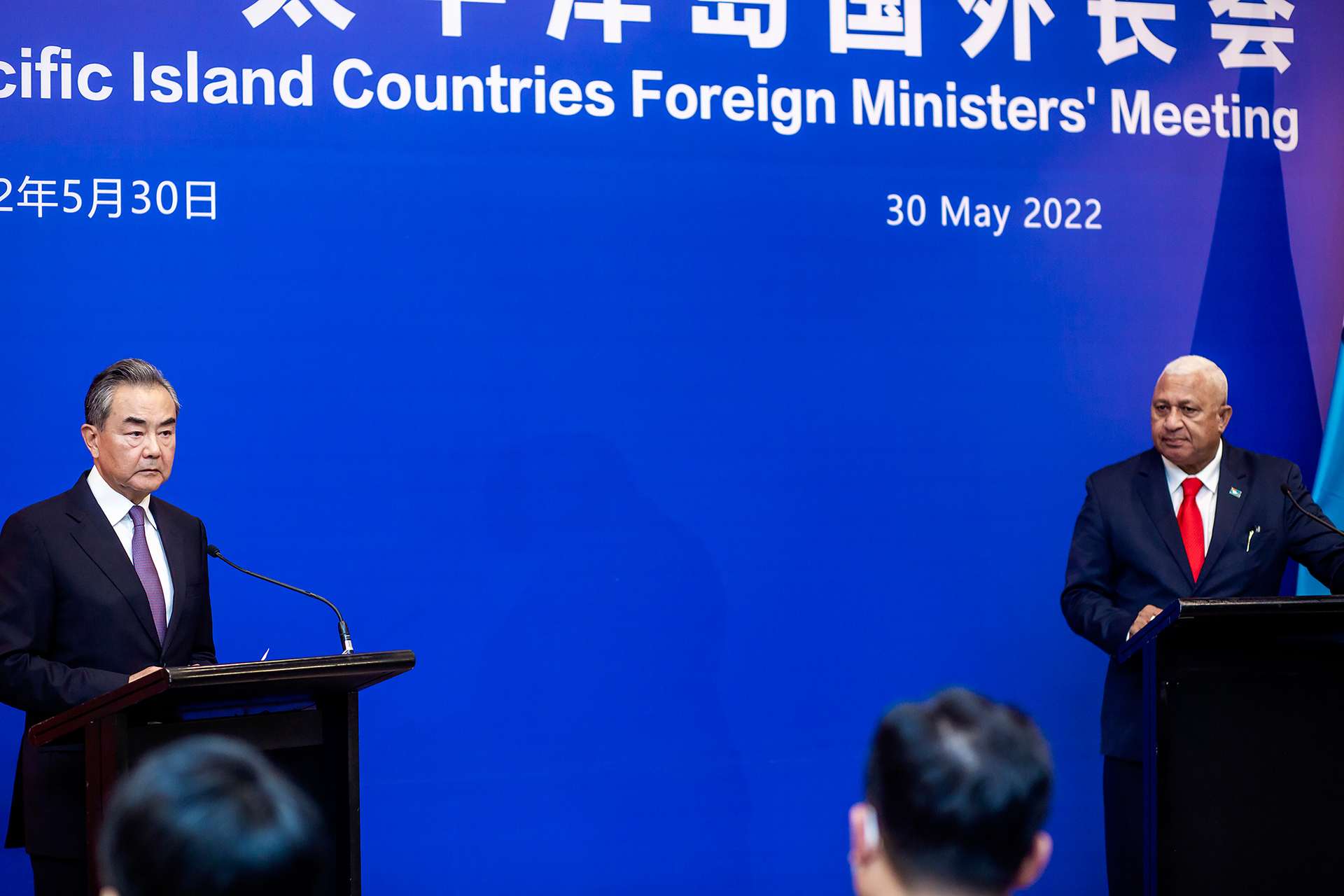China's Foreign Minister Wang Yi, left, appears on stage at the Pacific Islands Foreign Ministers' meeting with Fiji's Prime Minister Frank Bainimarama. Photo / AP