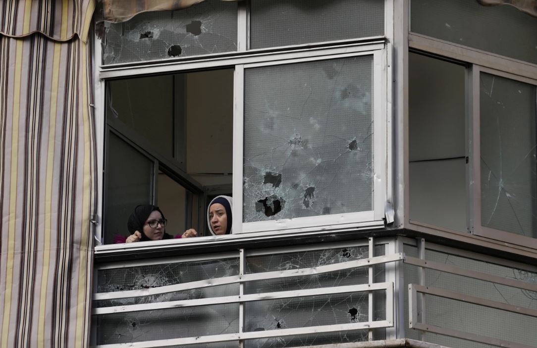 Lebanese women sit in an apartment building where an apparent Israeli strike occurred. Photo / AP