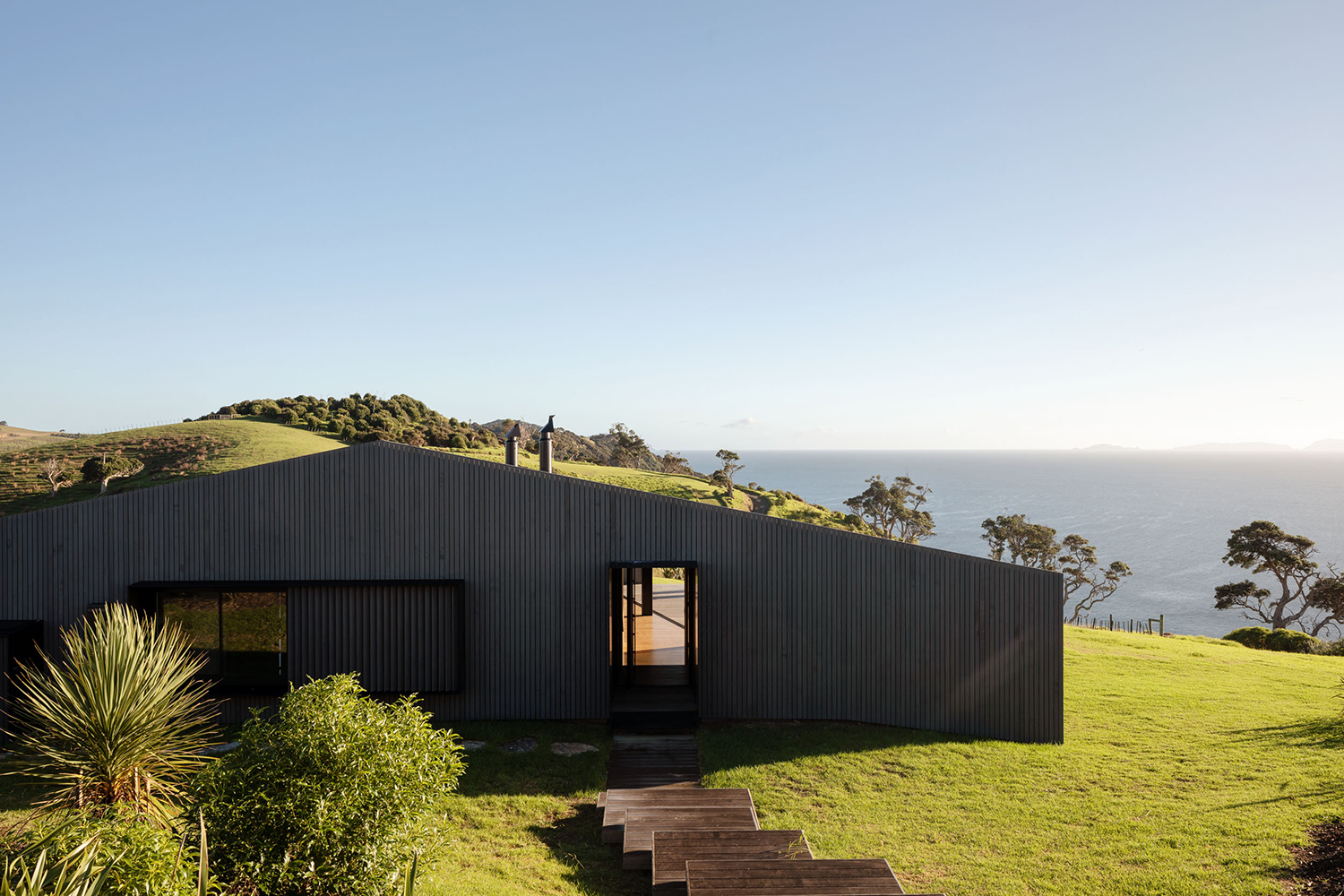 The gabled roof gives the triangle-shaped house a farmhouse facade from this angle. Photo / Simon Wilson