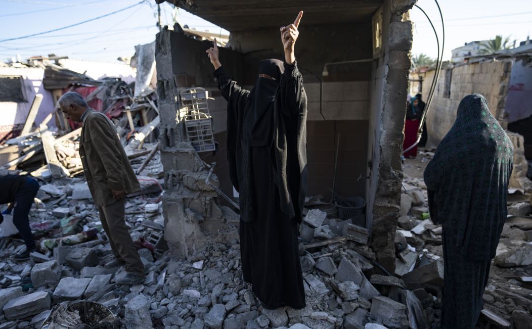 Palestinians look at the destruction after an Israeli strike in Rafah, southern Gaza Strip, Thursday, Jan. 18, 2024. (AP Photo/Fatima Shbair)