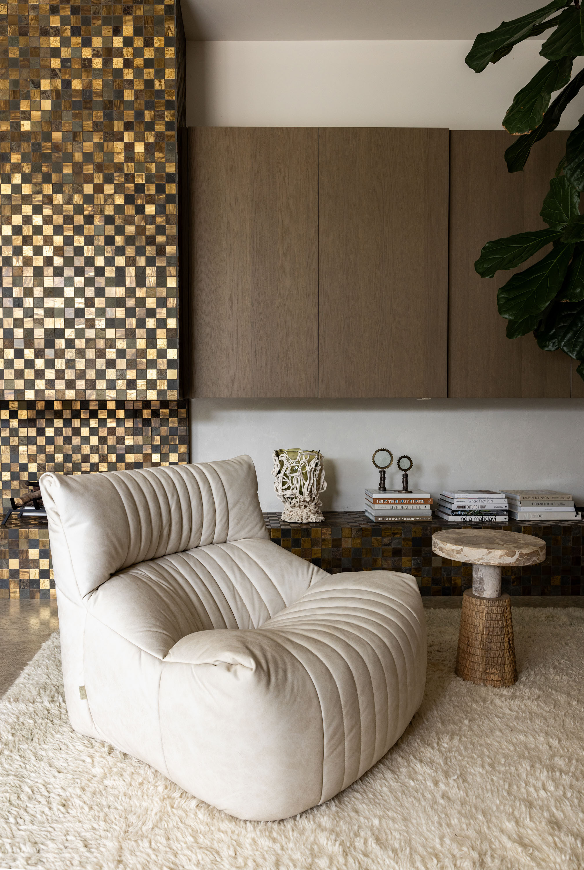 A vintage Aralia lounge chair by Michel Ducaroy for Ligne Roset. Jodi concealed the fireplace by Naked Flame with tiles from Tile Space, created to her design. The resin vase by Gaetano Pesce is from Design 55. Photo / Babiche Martens