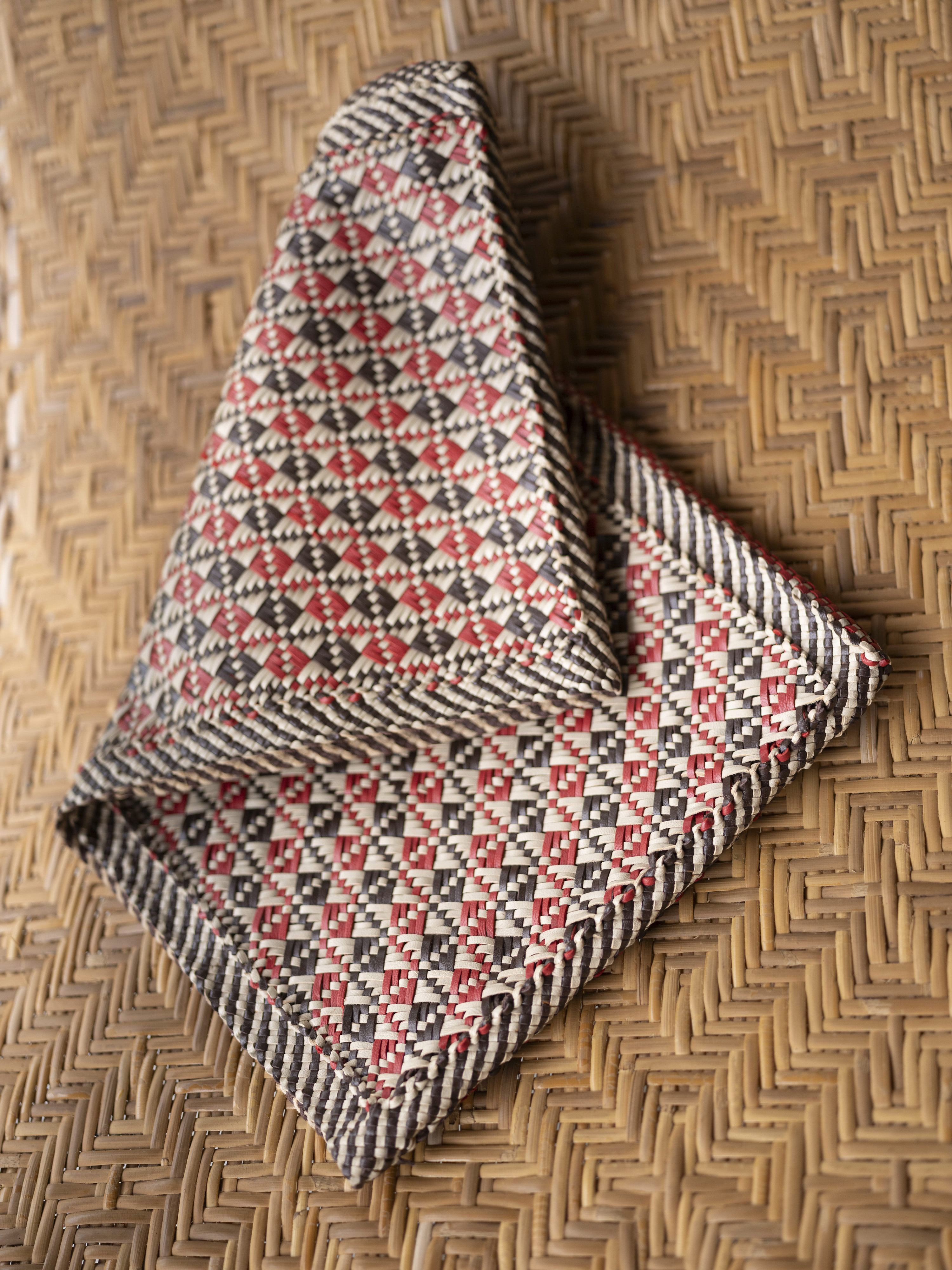 A pochette being woven, left, in the style of Dragon Diffusion’s Maori Kete bag, right. Photo / Priyadarshini Ravichandran, The New York Times