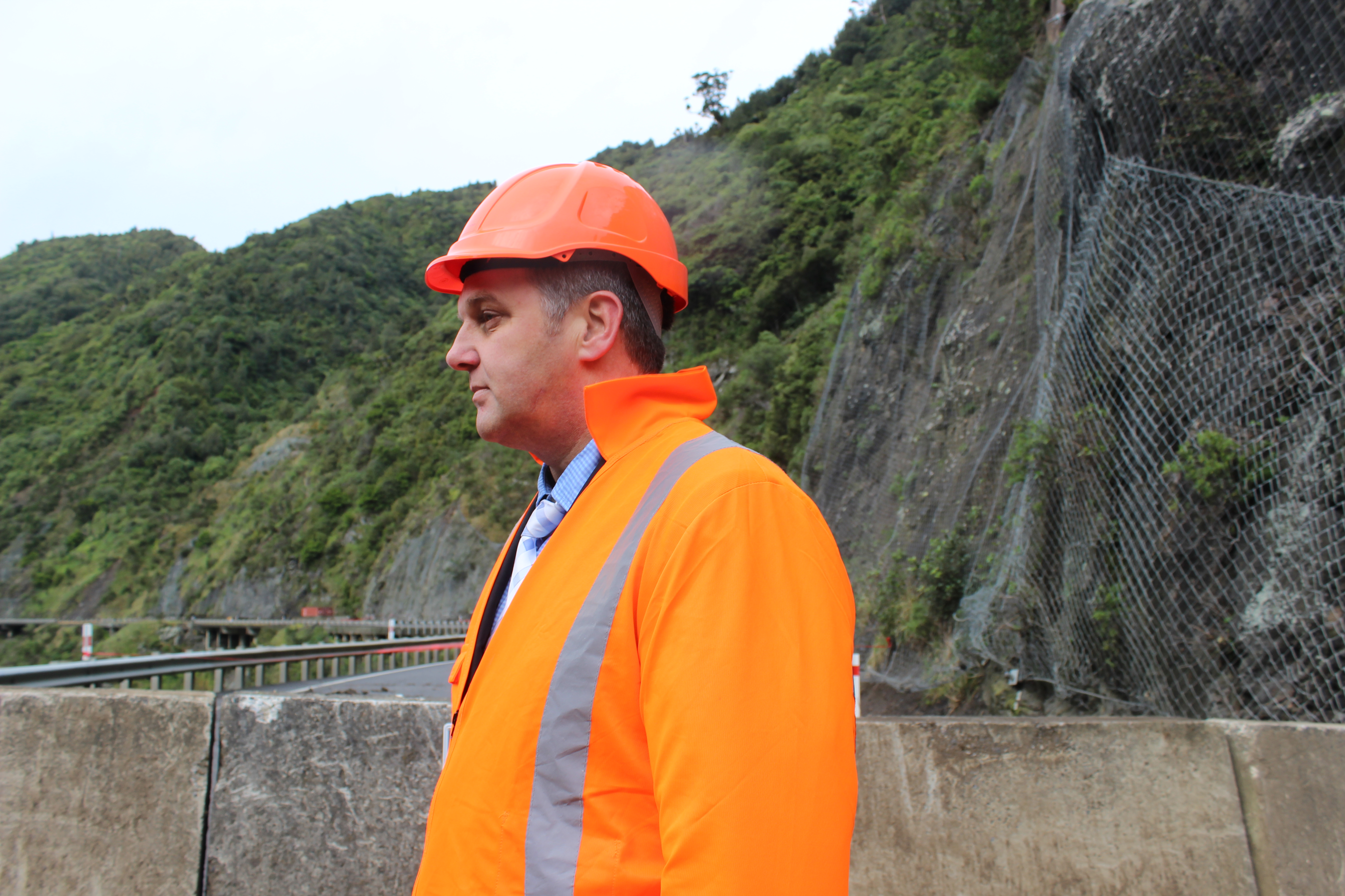 Ross I'Anson, NZTA regional transport system manager, with the moving cliff face behind him. Photo / Christine McKay