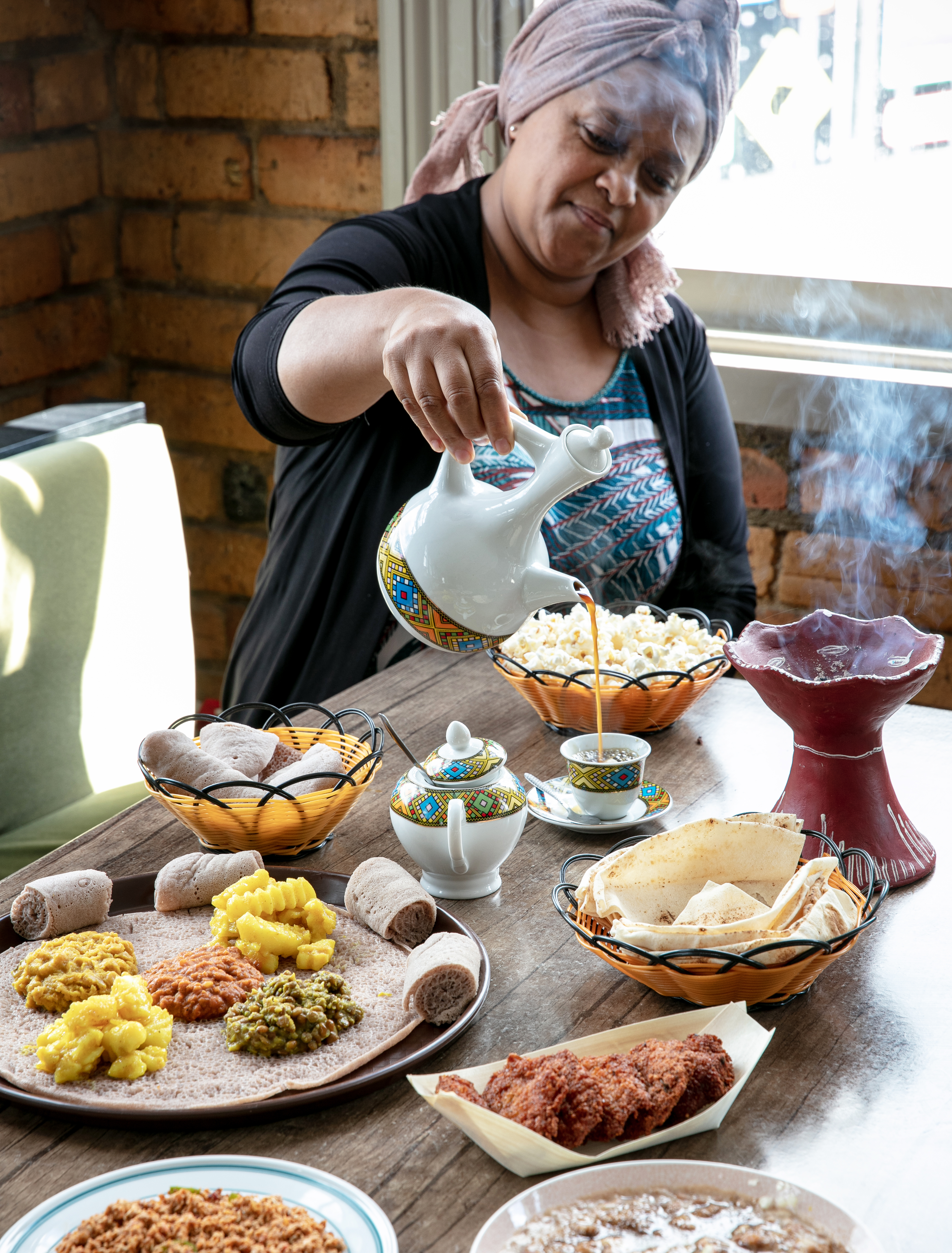 Ethiopian coffee being poured alongside the beyaynetu, falafel, shakshuka and ful on the menu at Yala Lounge in Dominion Rd. Photo / Babiche Martens