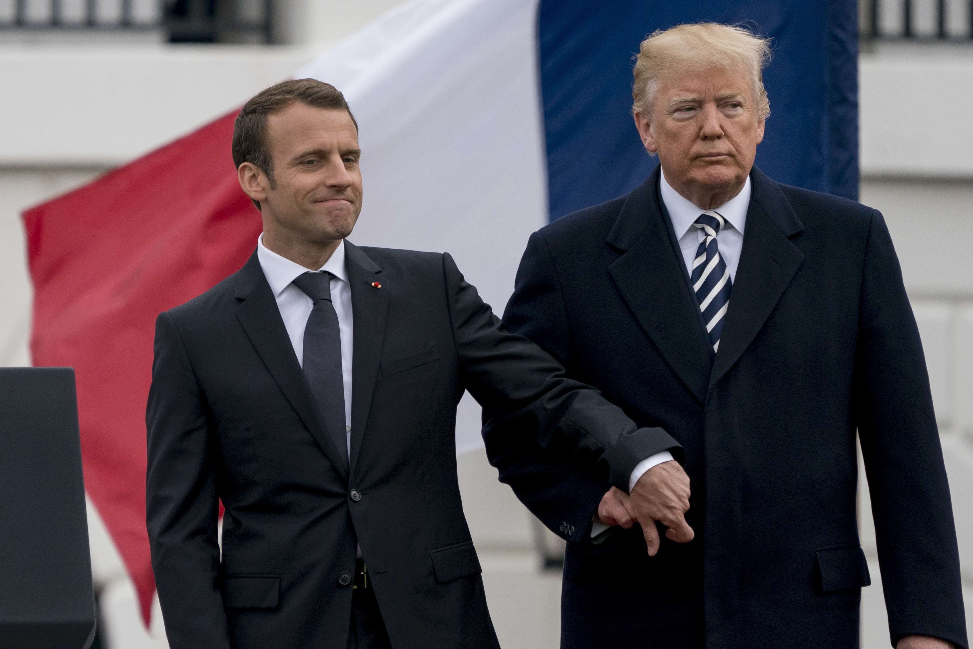 Then-US President Donald Trump and French President Emmanuel Macron hold hands during a ceremony at the White House. Photo / AP