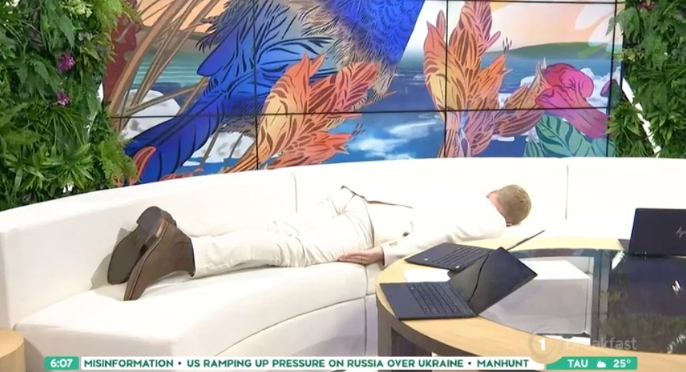 The Breakfast reporter blends in with the couch in his white outfit. Photo / The Spinoff