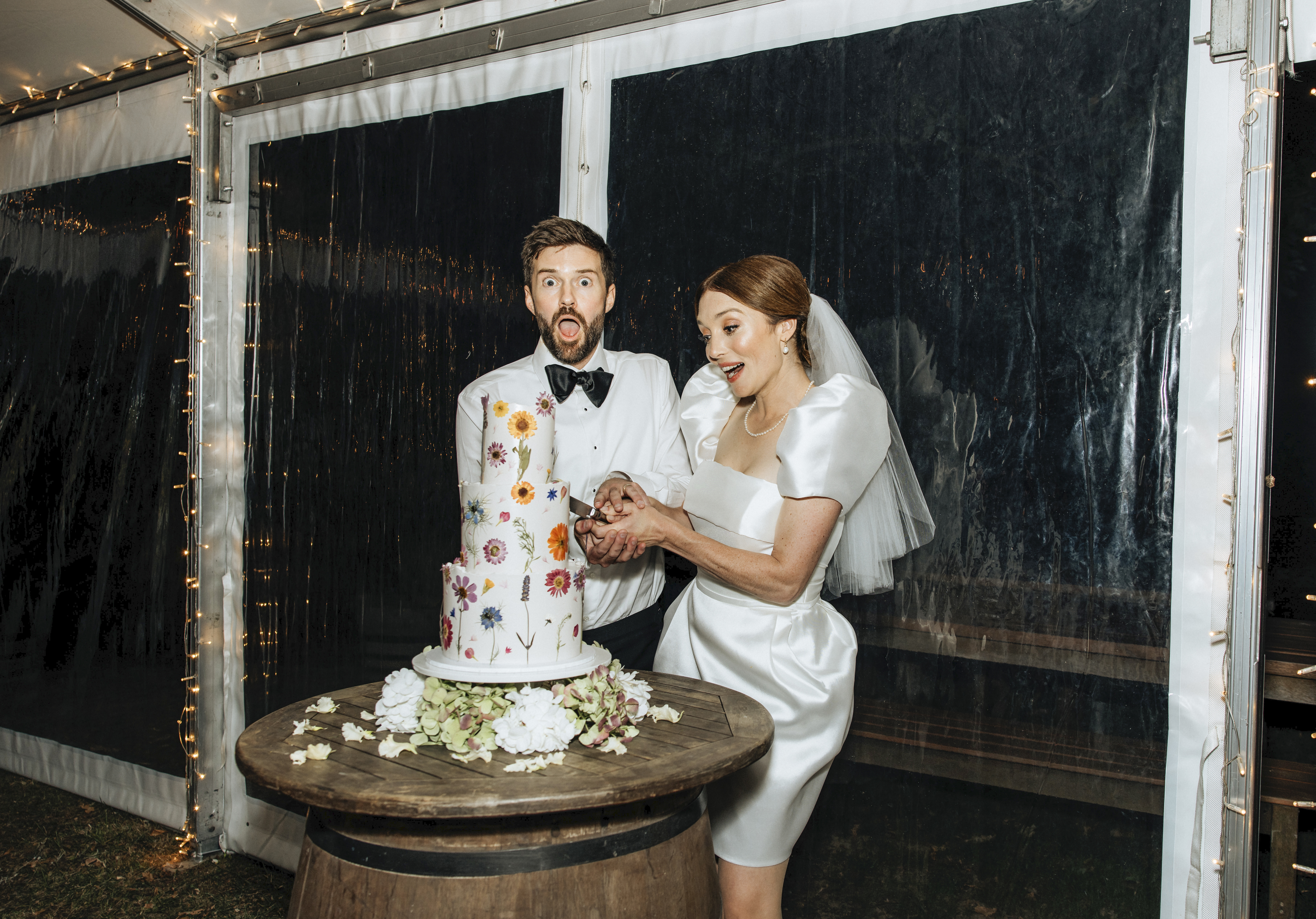 The couple's cake was a three-tiered combination of gluten-free carrot cake and chocolate mud cake, by Lilith Waiheke Cake Studio. Photo / Wildfolk Photography
