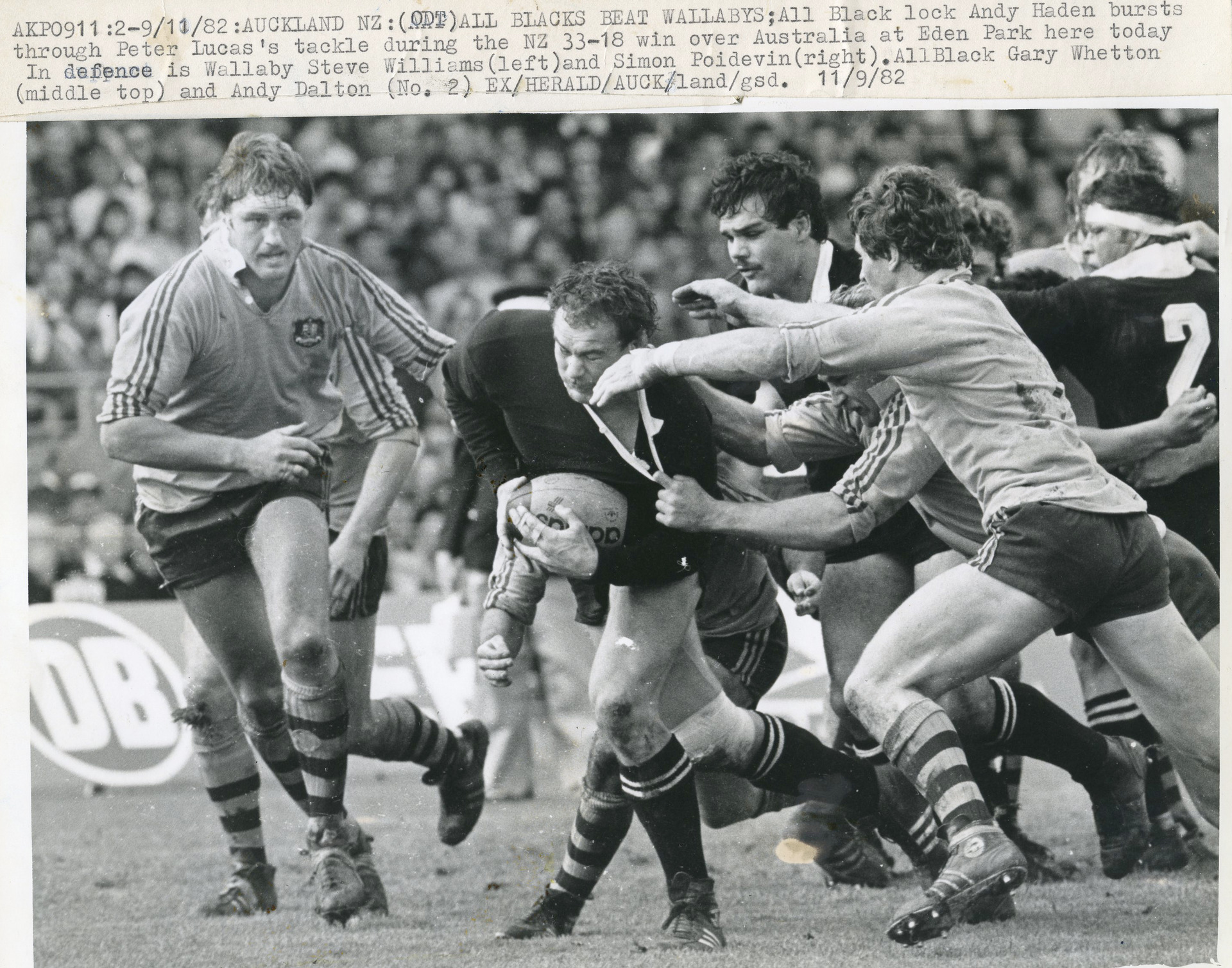 All Black lock Andy Haden bursts through the tackle of Wallaby Peter Lucas in New Zealand's 33-18 win at Eden park on 11 September 1982. Photo / Ross Land
