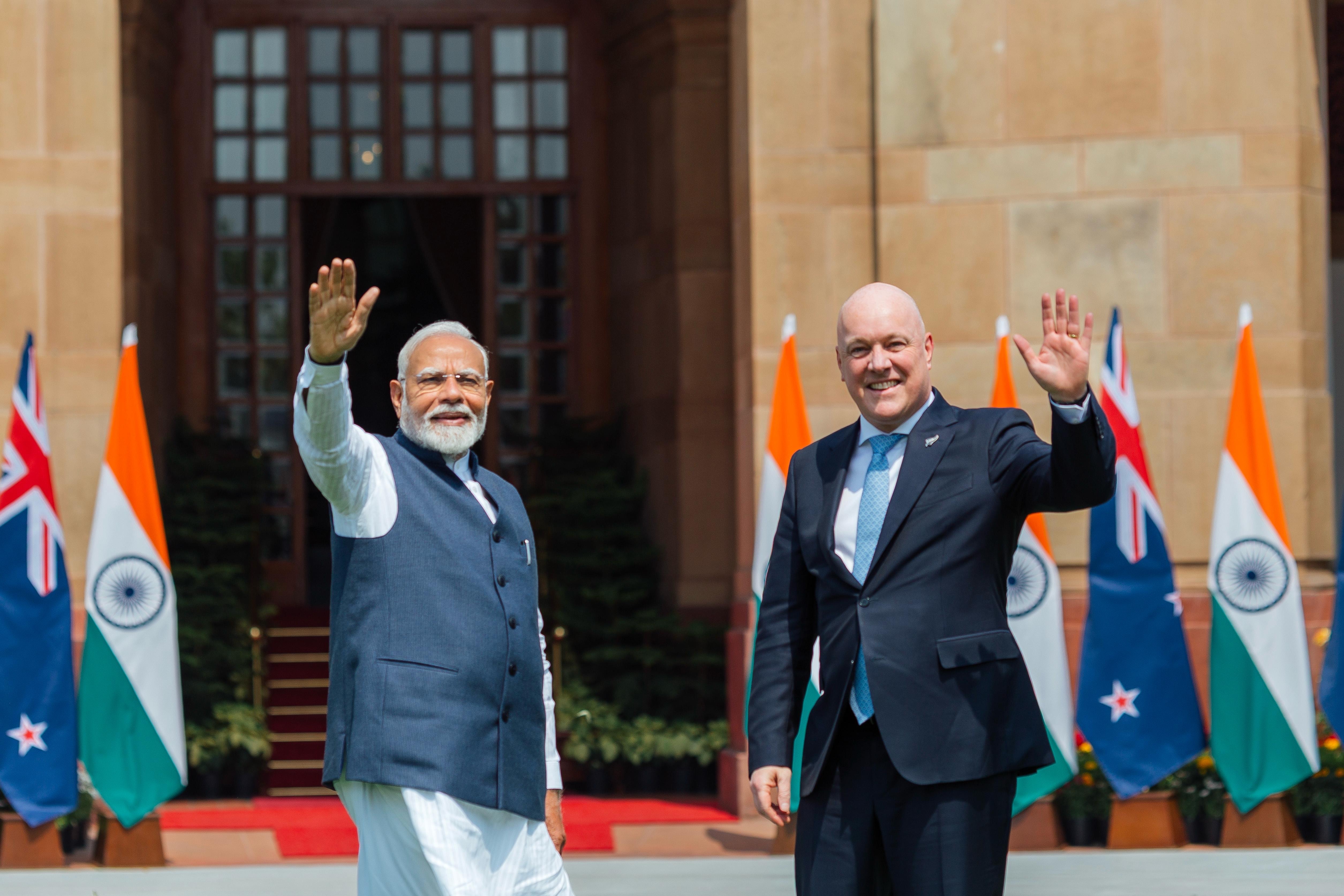 Prime Minister Christopher Luxon and India PM Narendra Modi wave at media ahead of their bilateral meeting. Photo / Interest.co.nz