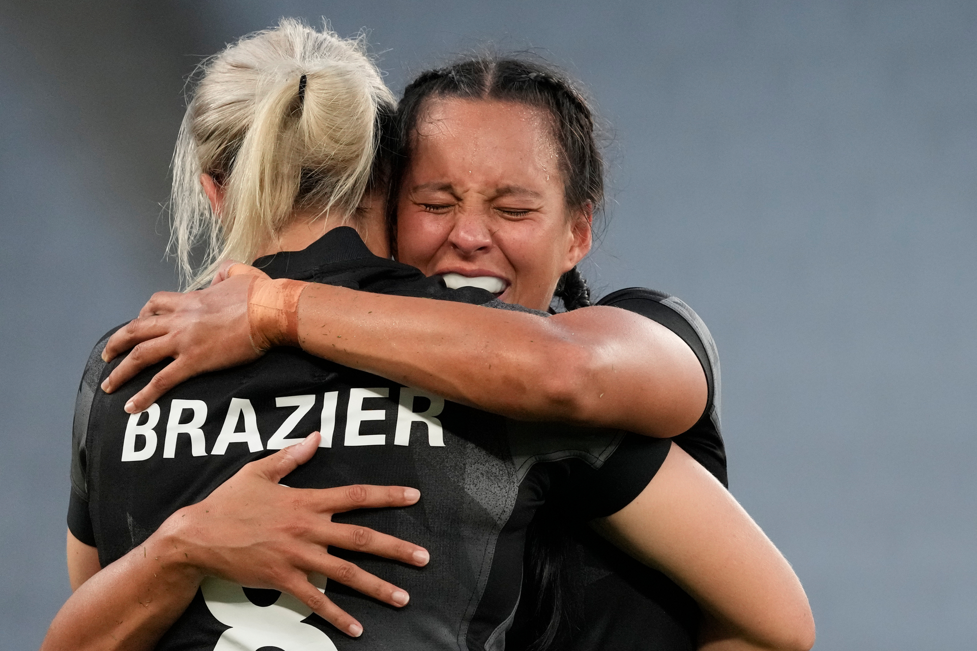 New Zealand's Tyla Nathan-Wong, right, hugs her teammate Kelly Brazier as they celebrate winning their women's rugby sevens gold medal match against France. Photo / AP