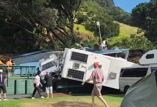Campers are seen on the roof of the ablution block at the Mount Maunganui campground immediately after Thursday's landslide. Photo / Bill Baker