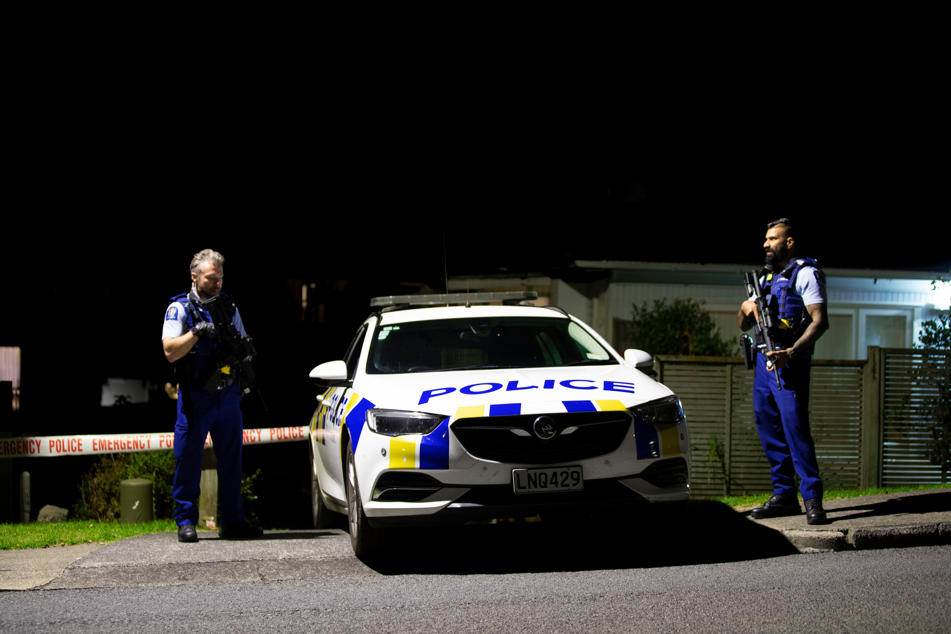 Police outside a property in Ōpaheke, South Auckland last night following a shooting. Photo / Hayden Woodward