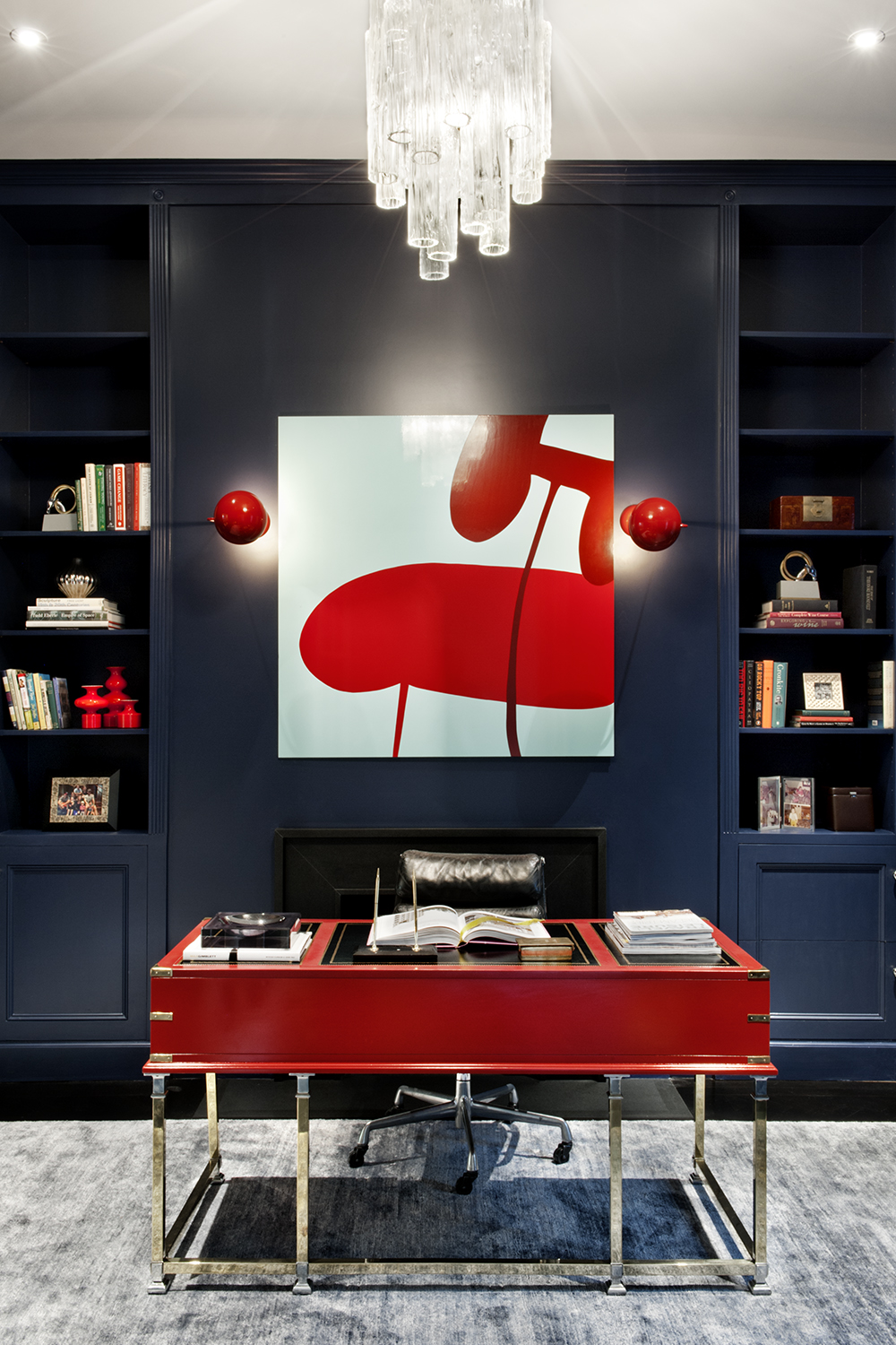 A striking red desk and navy wall in a Chelsea townhouse. Photo / Emily Andrews