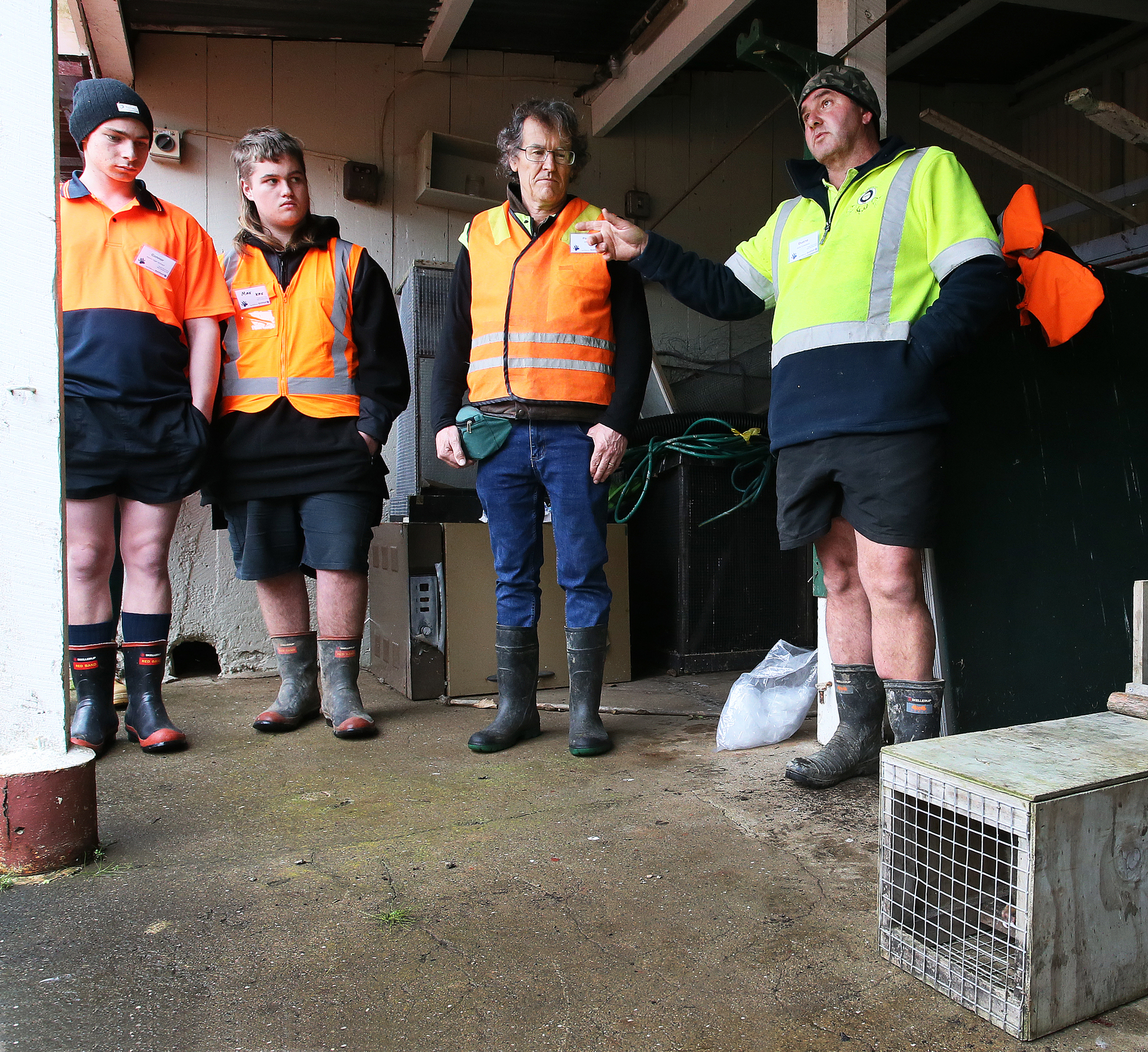 Duane Doughty, of the DoC, tutors the students on how to set traps for pests. Photo / Tania Whyte