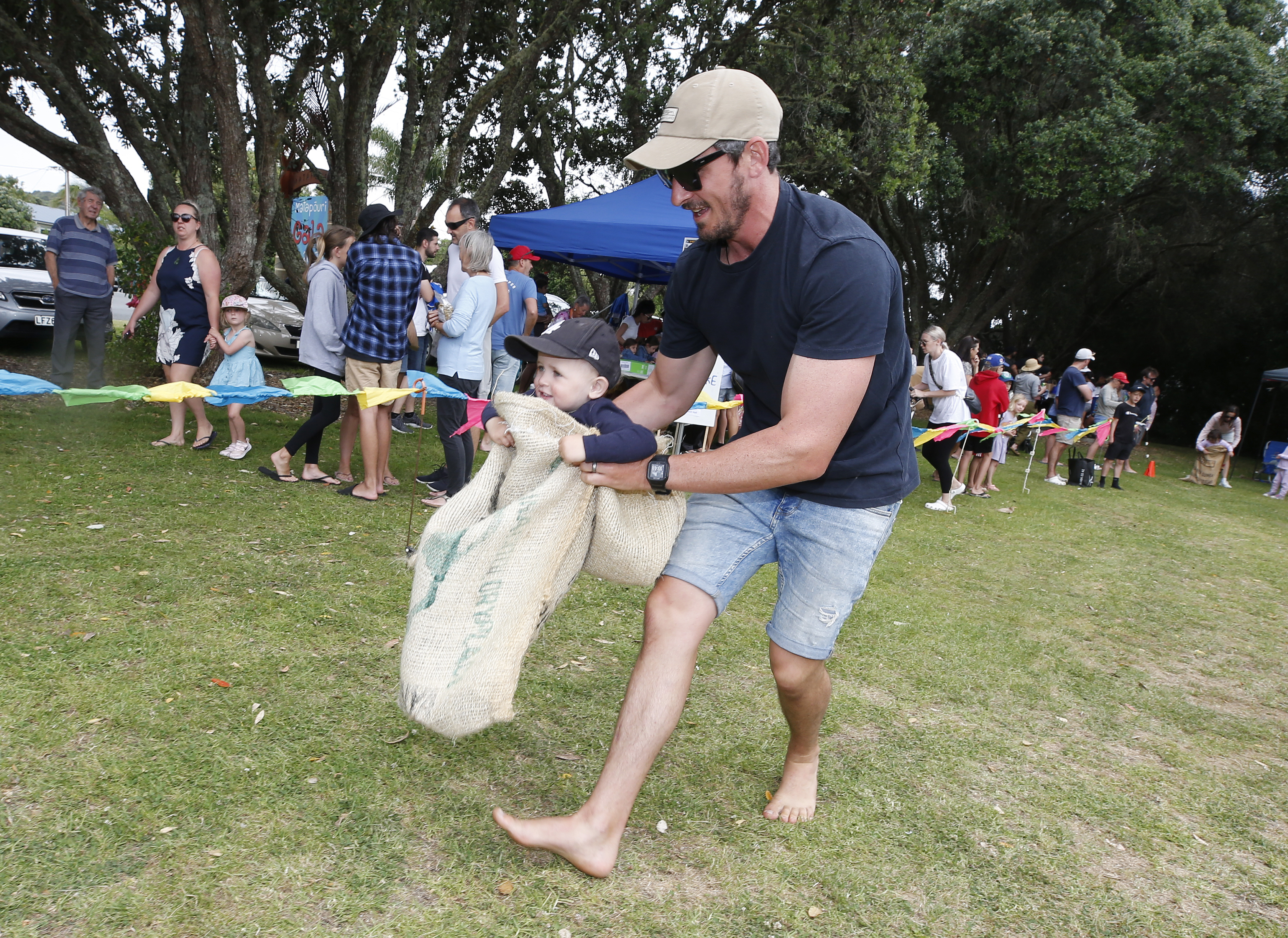 Dad Mark Lyons and son Jack Lyons, 2, from Auckland, make their own fun during races at Matapouri Gala Day.