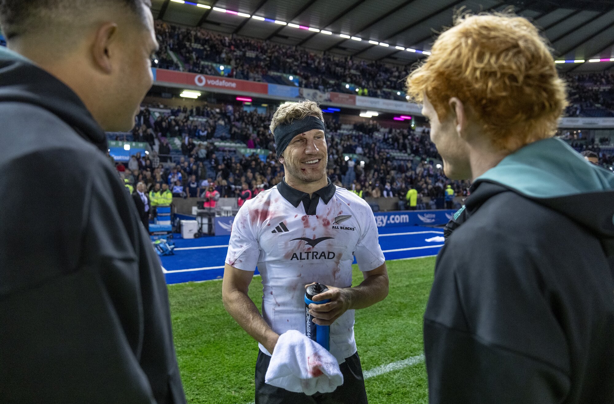 All Blacks match-winner Damian McKenzie talks with teammates after beating Scotland at Murrayfield. Photo / SmartFrame