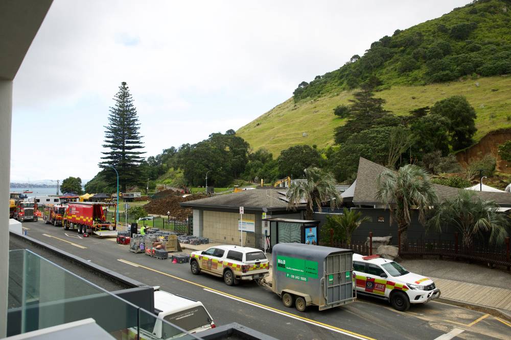 Police, fire and emergency services at Mount Maunganui campground. At least six people are unaccounted for after a massive landslide destroyed parts of the iconic Mount Maunganui campground. Photo / Jason Dorday