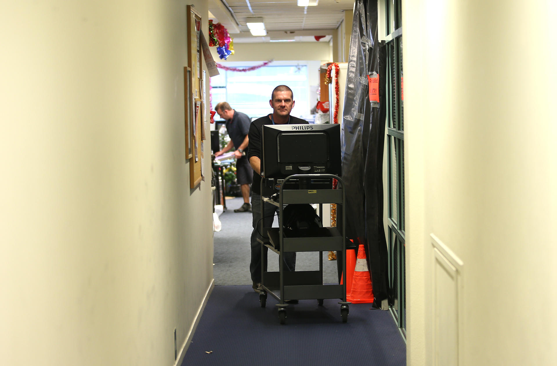 Staff evacuate the office space in Tauranga City Council's first floor after the discovery of toxic black mould, several days before Christmas 2014. Photo / NZME