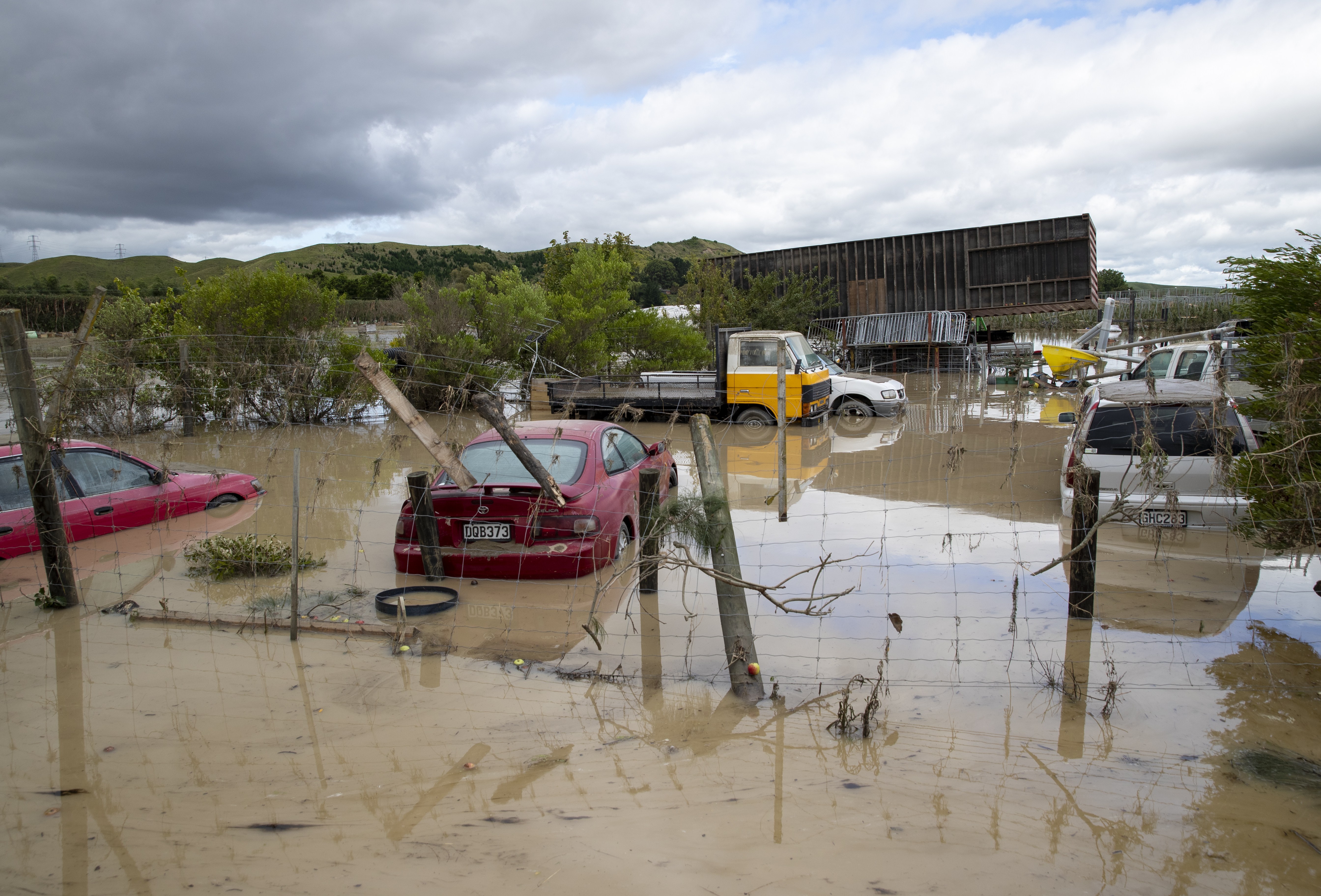 Vehicles sit amid debris and floodwaters in Puketapu Rd, west of Napier, on February 16. Photo / Mark Mitchell