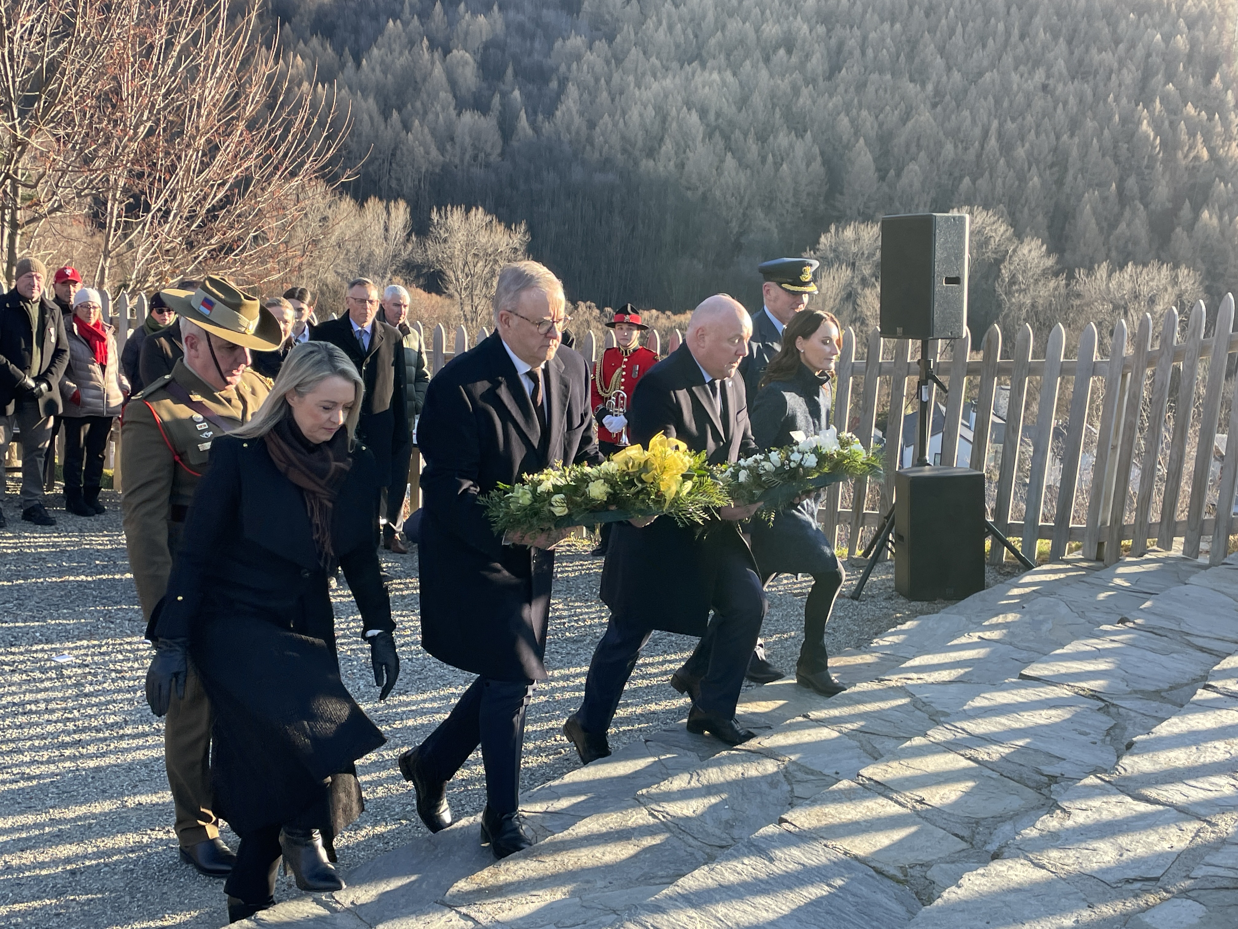 Australian Prime Minister Anthony Albanese (front, second from left), his partner Jodie Haydon (front left) with New Zealand Prime Minister Christopher Luxon (third from front left) and his wife Amanda at a wreath-laying ceremony at the War Memorial in Arrowtown. Photo / Derek Cheng