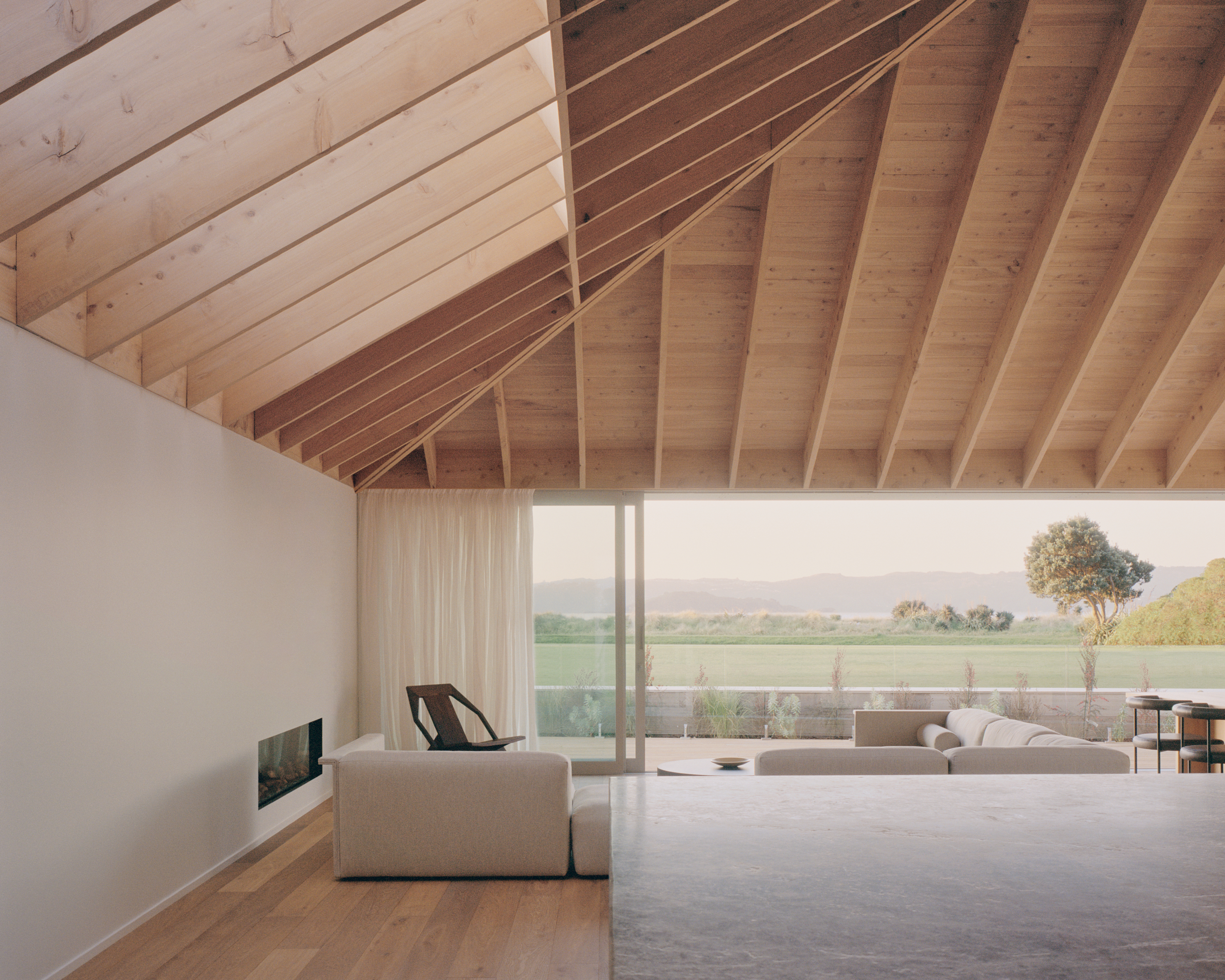 The vaulted ceiling in the living pavilion is clad in macrocarpa. Photo / Rory Gardiner