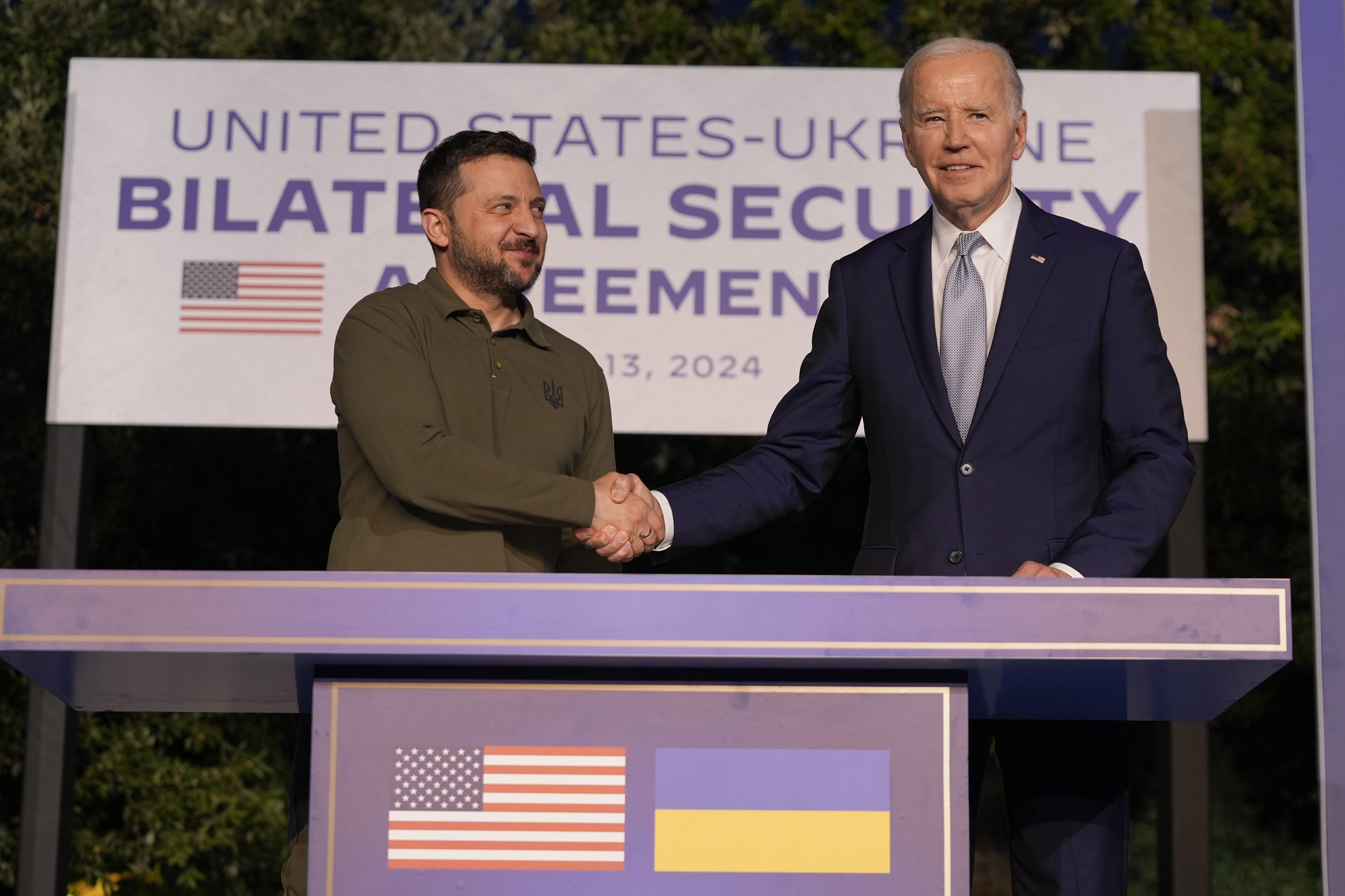 US President Joe Biden and Ukrainian President Volodymyr Zelenskyy shake hands after signing a bilateral security agreement on the sidelines of the G7 summit. Photo / AP