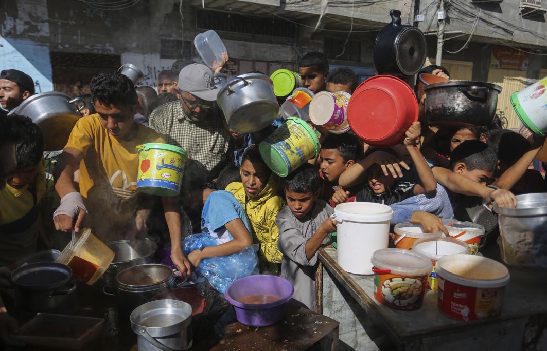 Palestinians crowded together as they wait for food distribution in Rafah, southern Gaza Strip. Photo / AP