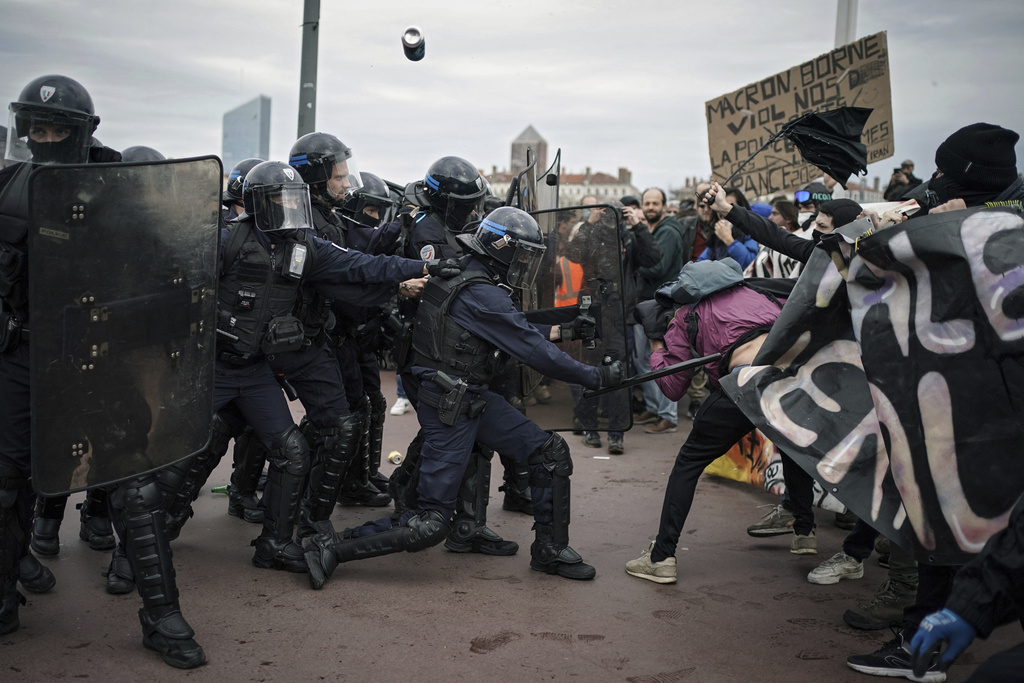 Protesters clash with police officers during a demonstration in Lyon, central France on March 23. Against this backdrop it was decided that a state visit by King Charles should be postponed. Photo / AP
