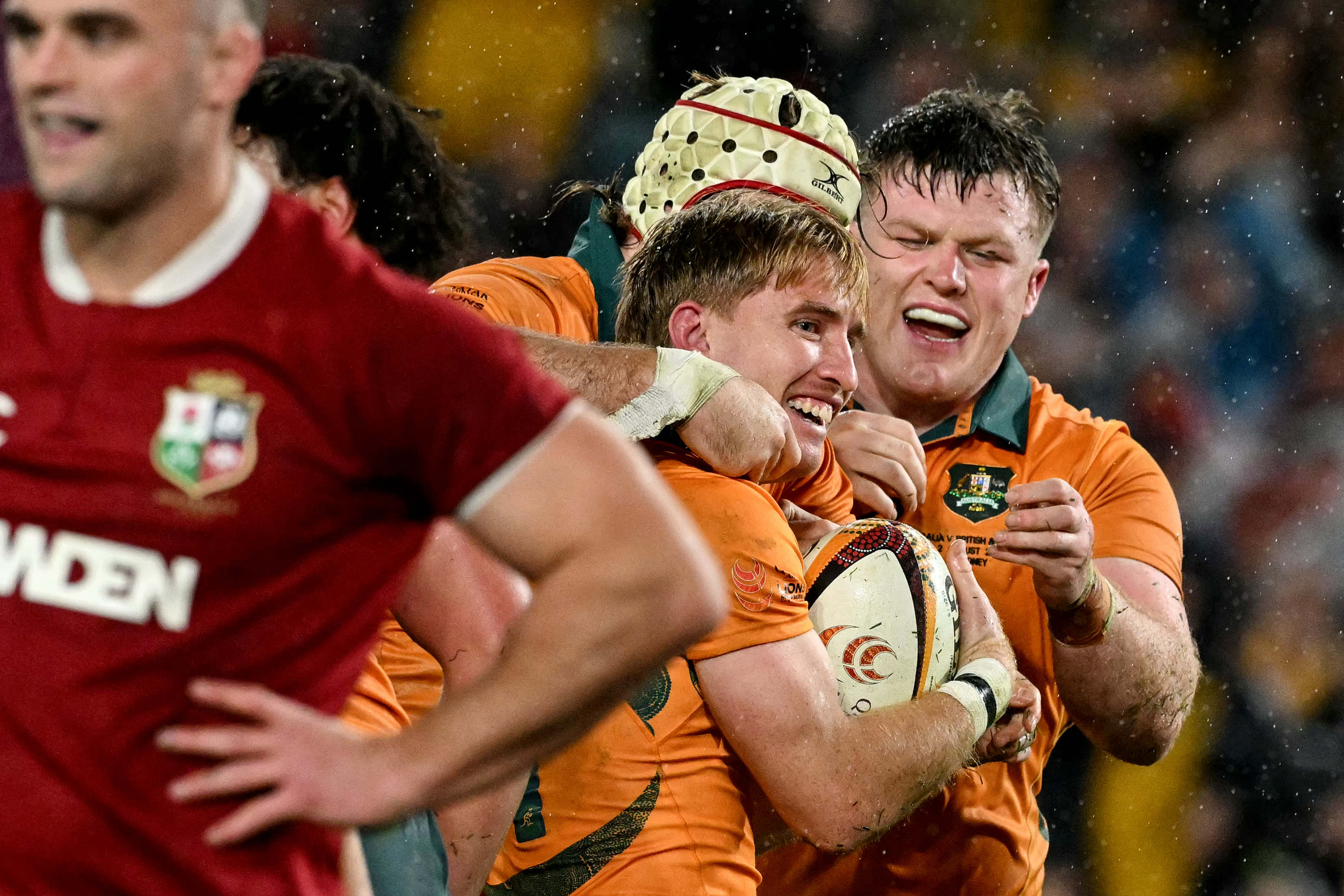 Australia's Tate McDermott celebrates a try with teammates during the third rugby test match between Australia and the British and Irish Lions. Photo / AFP