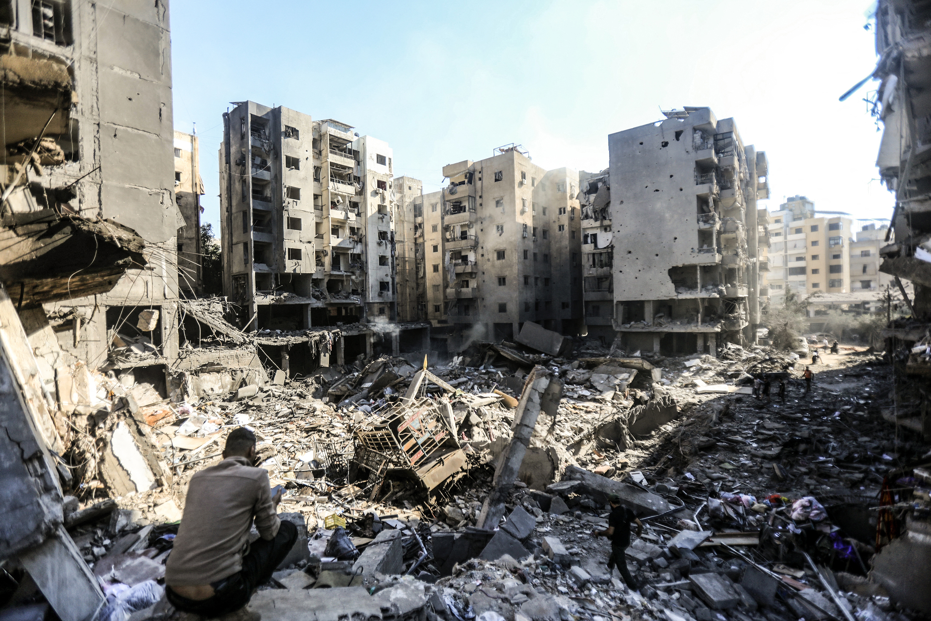 People check the rubble of buildings which were levelled on September 27 by Israeli strikes in the Haret Hreik neighbourhood of Beirut's southern suburb. Photo / AFP