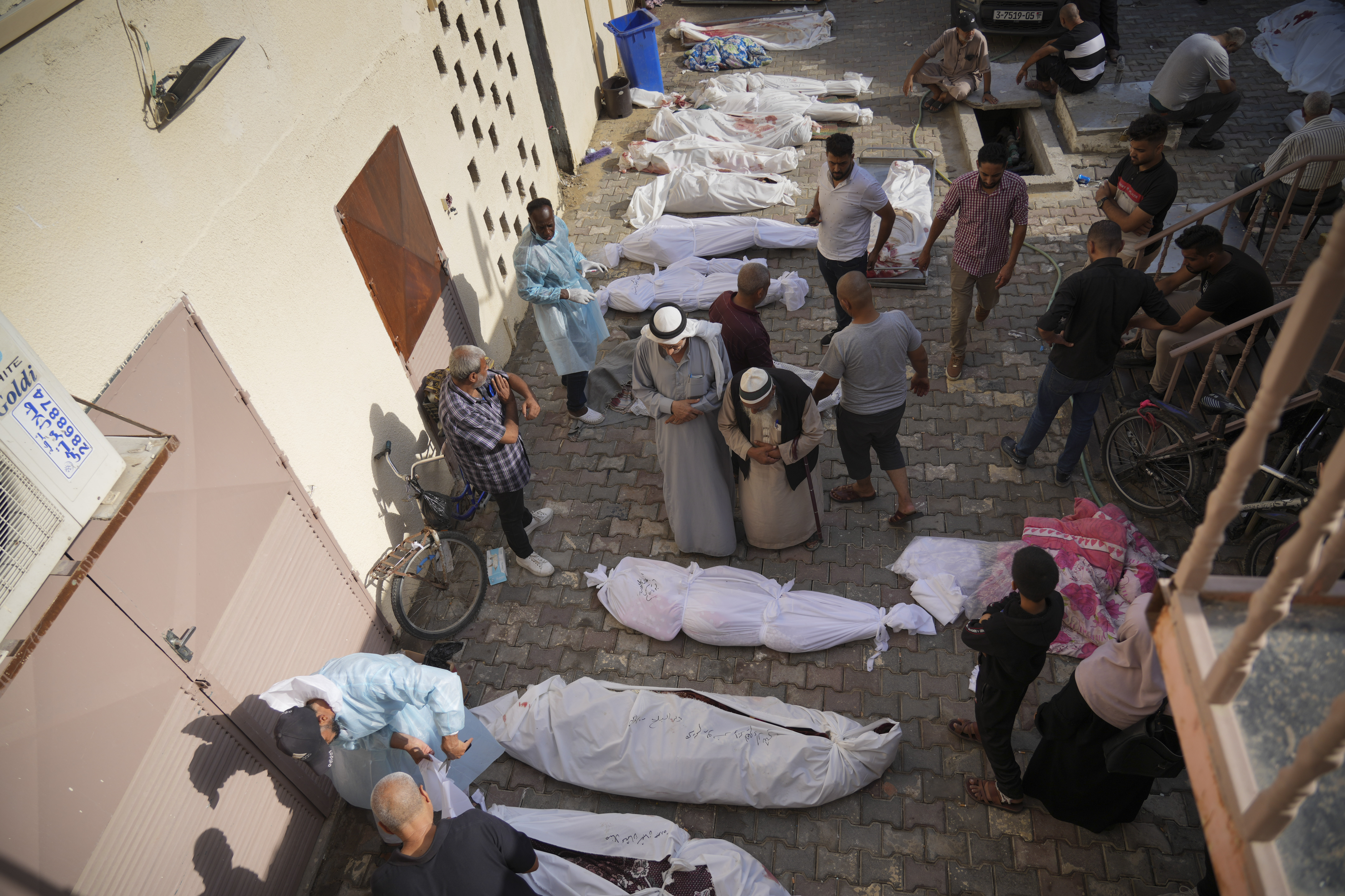 Friends and relatives stand by the bodies of Palestinians killed in the Israeli bombardment of the Gaza Strip at Al-Aqsa Hospital in Deir Al-Balah. Photo / AP
