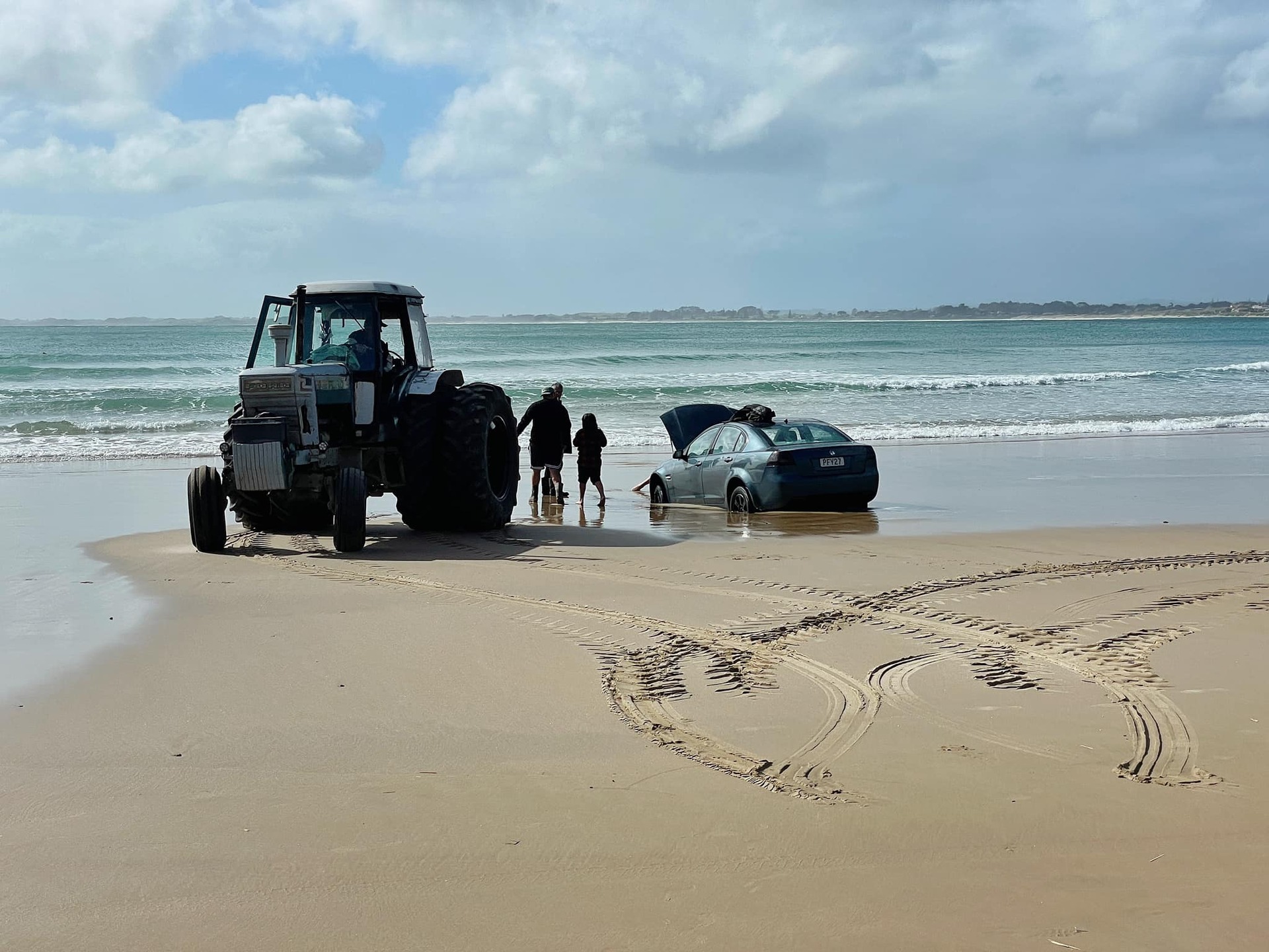 Ahiparapara resident, Paul Davies and his tractor, 'The Big Blue' pulled the stolen vehicle from the water at Te Kohanga (Shipwreck Bay). Photo/Lennox Goodhue-Wikitera.