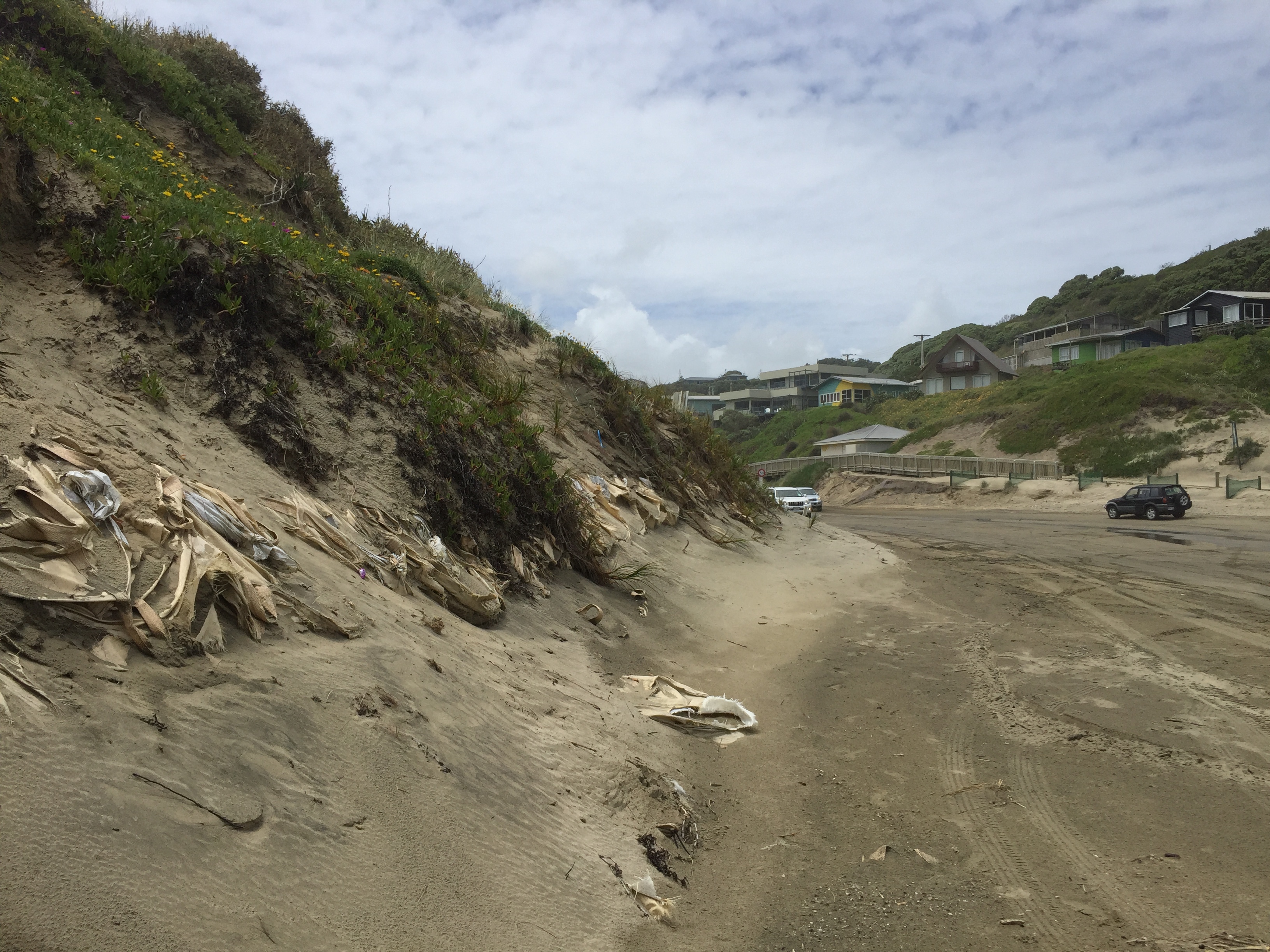 Visitors to Baylys Beach are met with exposed sandbags at the entrance, image from November 2022. Photo / Supplied