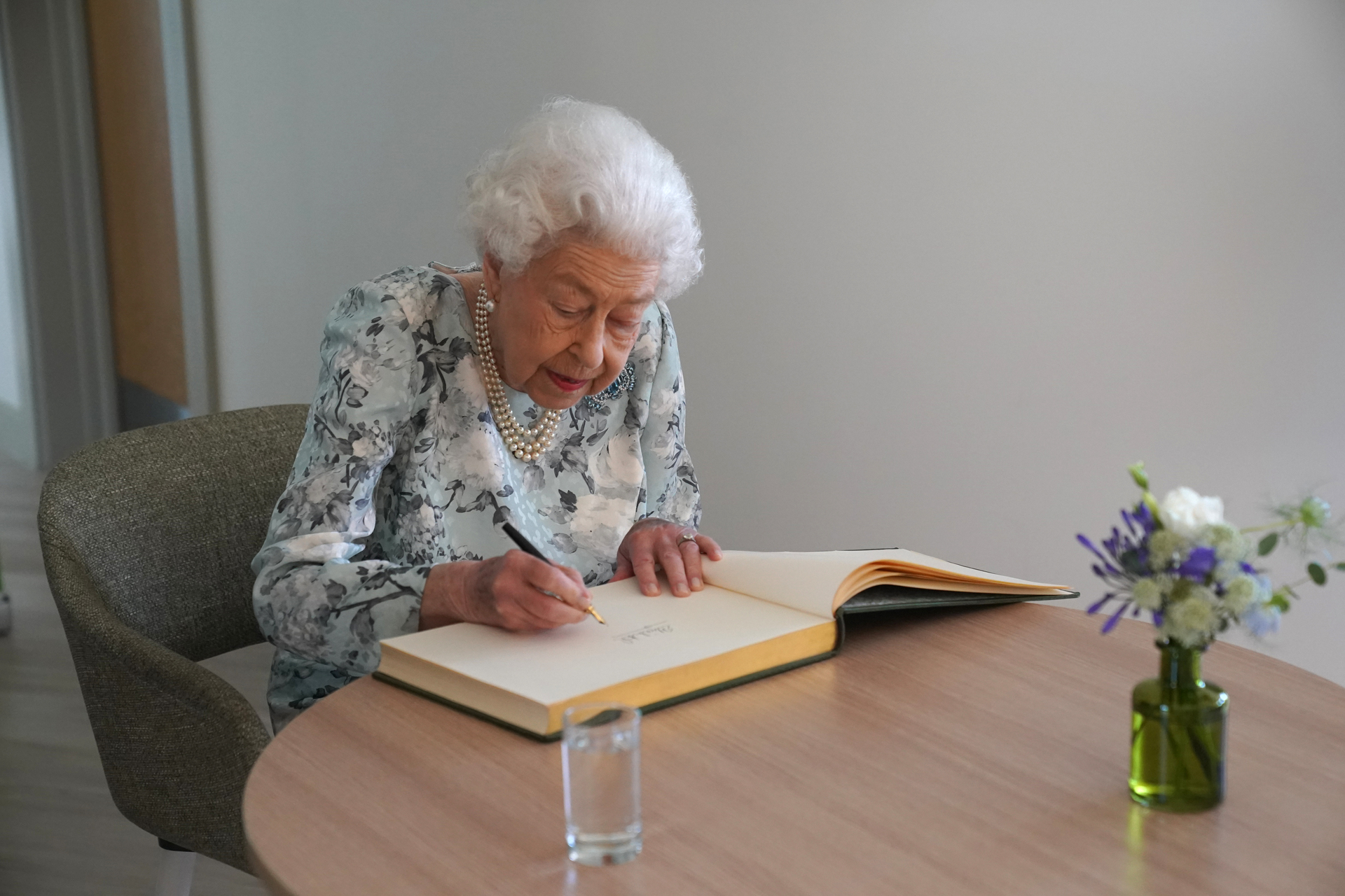 Britain's Queen Elizabeth II signs a guest book during a visit to officially open the new building of Thames Hospice in Maidenhead, Berkshire, on July 15, 2022. Photo / Getty Images