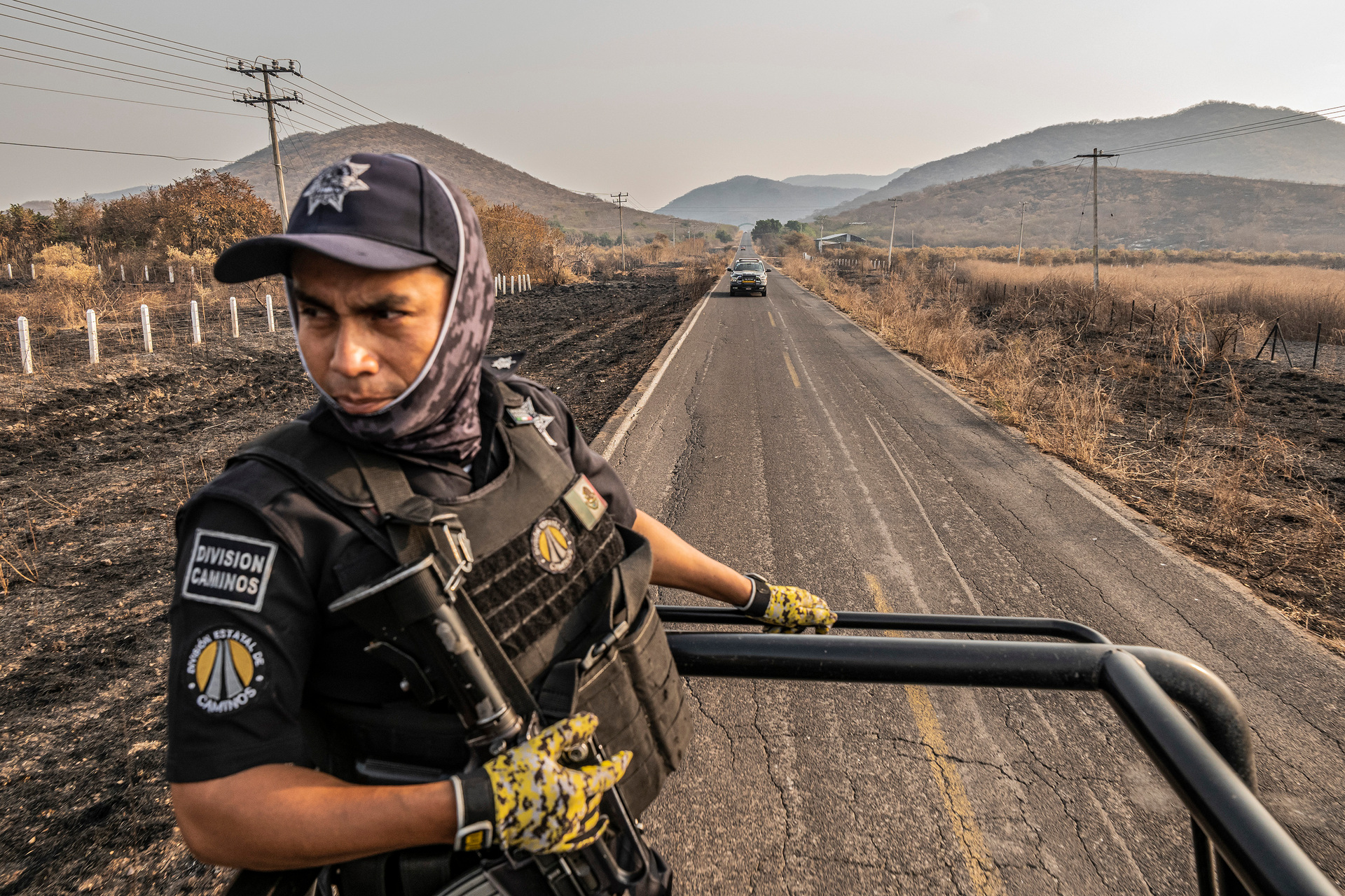 A police patrol moves past fields burned in conflict between cartels in El Limoncito, Michoacan, where small Mexican drug cartels competed with larger ones for territory, leaving residents in the middle of a brutal turf war. Photo / Daniel Berehulak, The New York Times