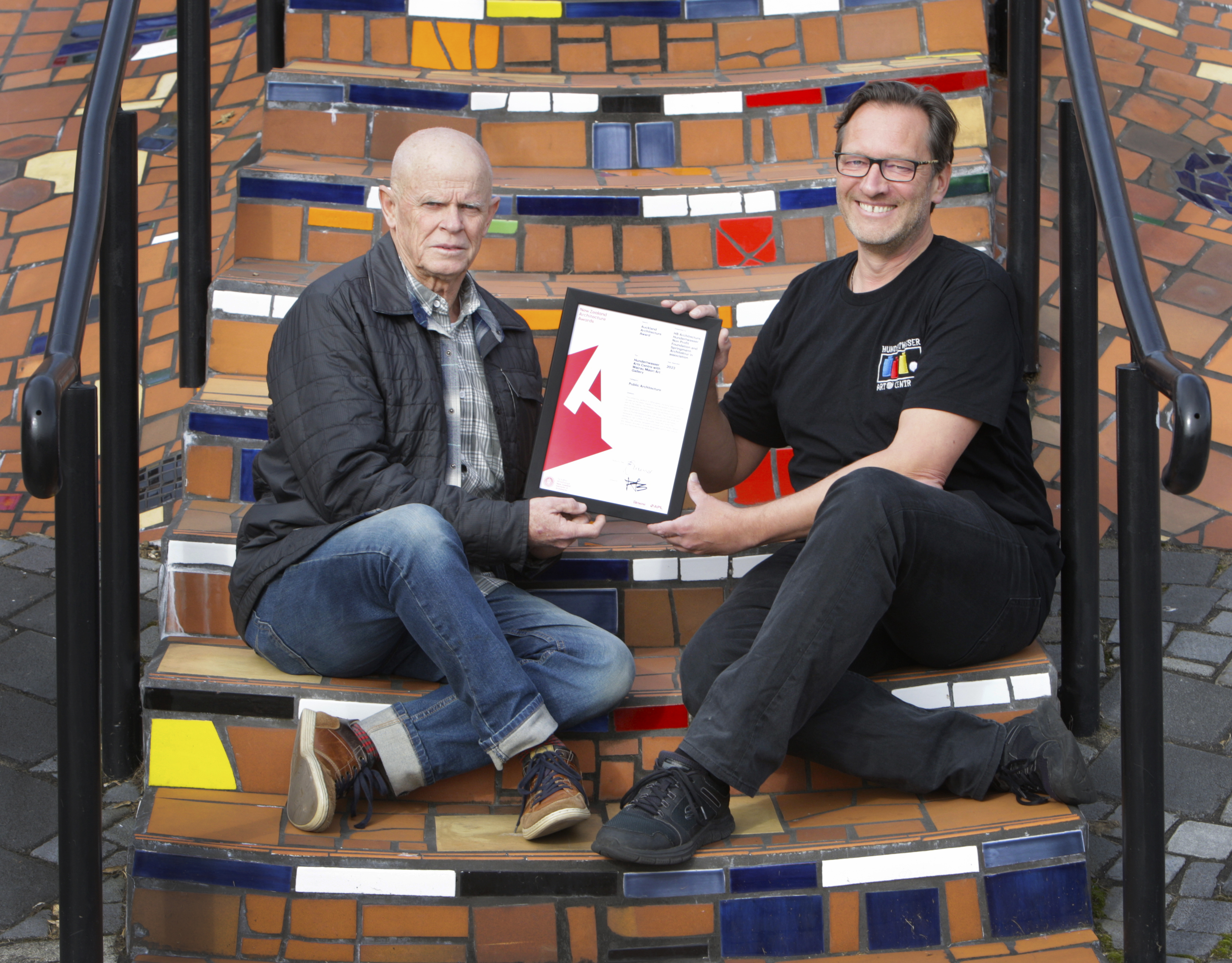 Whangārei-based architect Grant Harris (left) hands the certificate of recognition to the Hundertwasser Art Centre director, Joost de Bruin. Photo / Tania Whyte