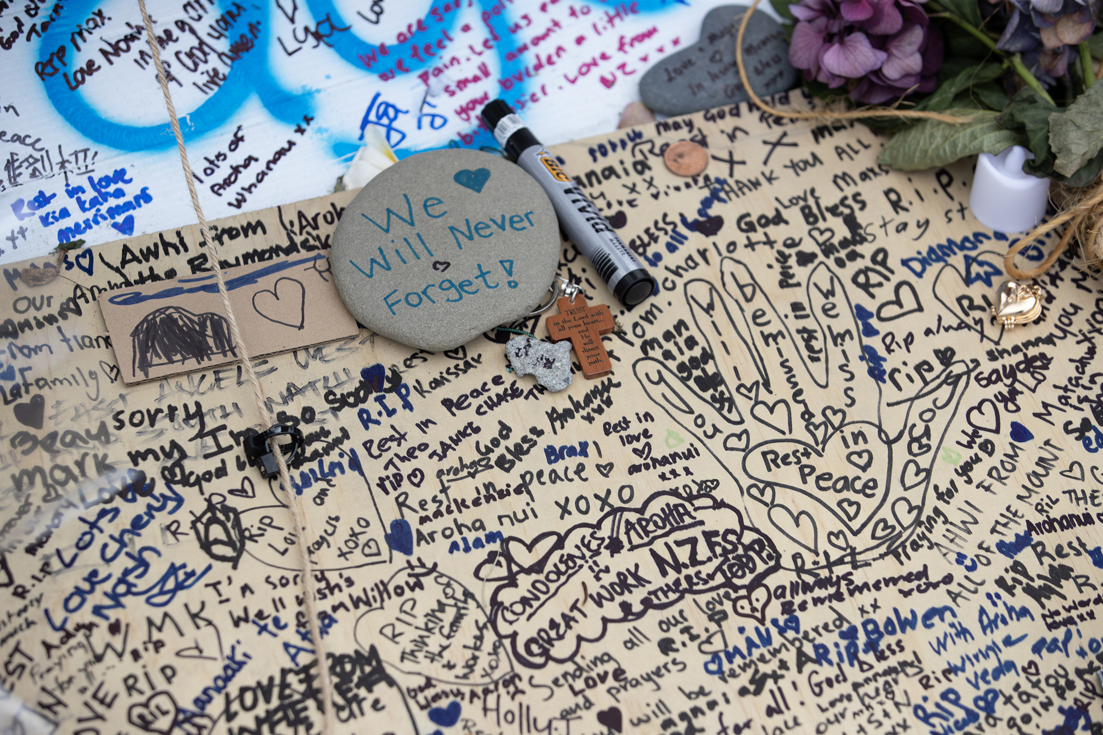 New Zealanders from all walks of life continue to show their support, laying flowers and writing tributes on what is now the tribute fence at the intersection of The Mall and Leinster Ave in Mount Maunganui. Photo / Hayden Woodward