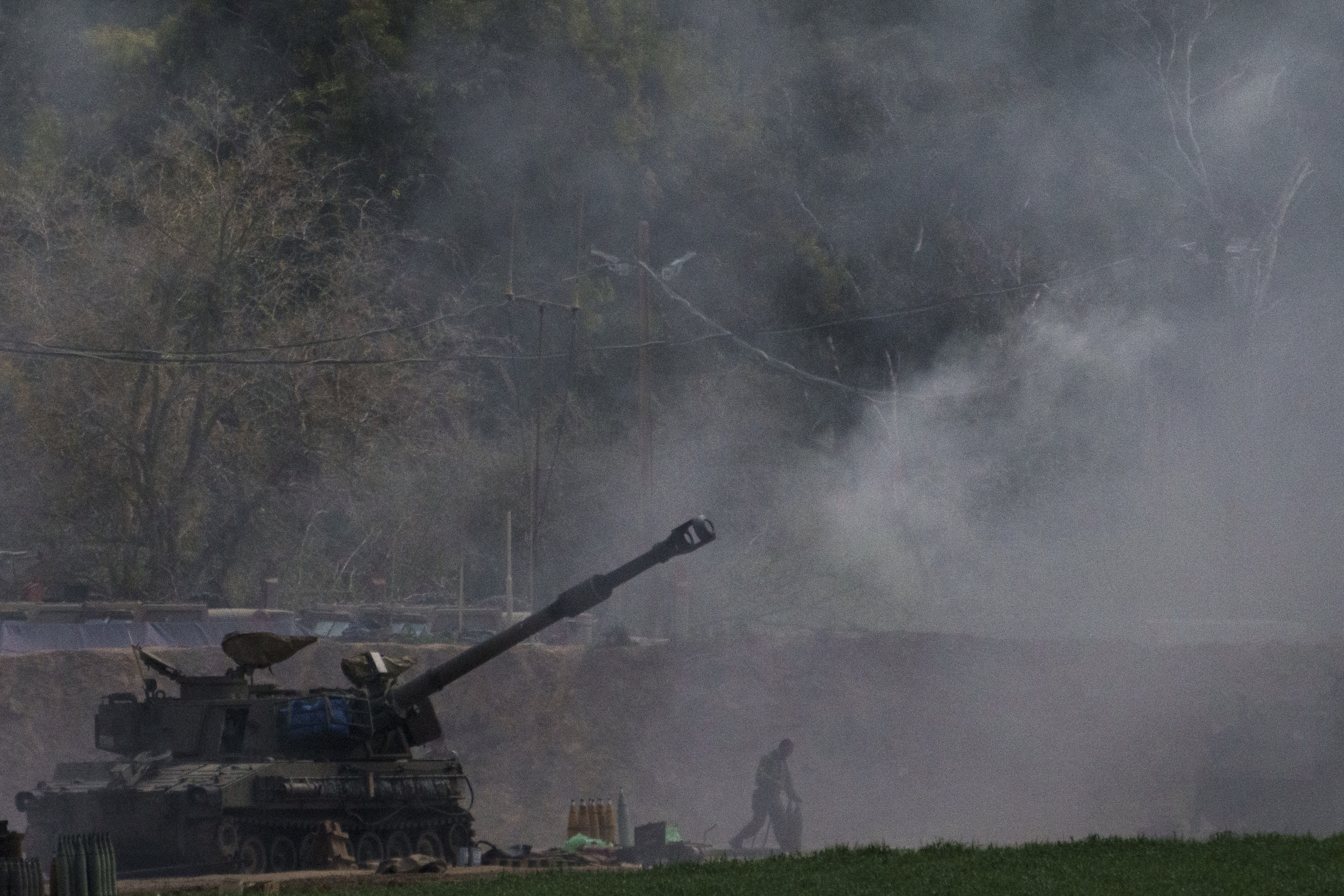An Israeli mobile artillery unit fires a shell from southern Israel towards the Gaza Strip, in a position near the Israel-Gaza border. Photo / AP