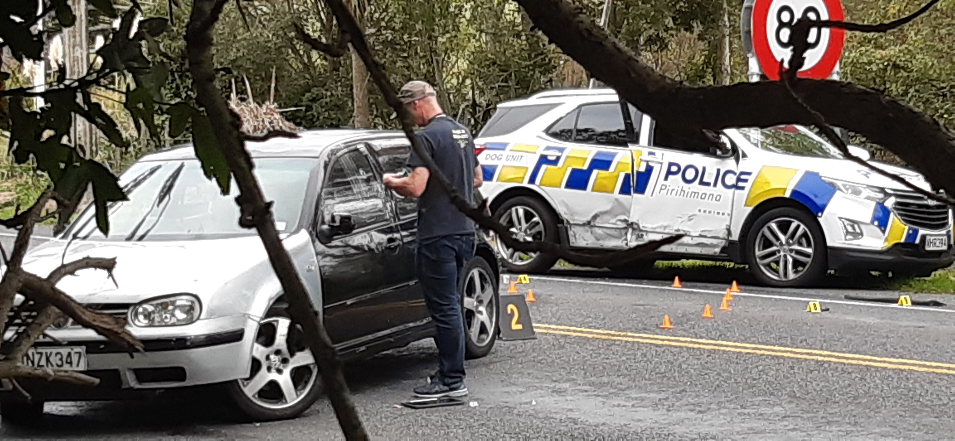 Police investigators marking up bullet holes in the Volkswagen driven by Kaoss Price, 22. Photo / Supplied