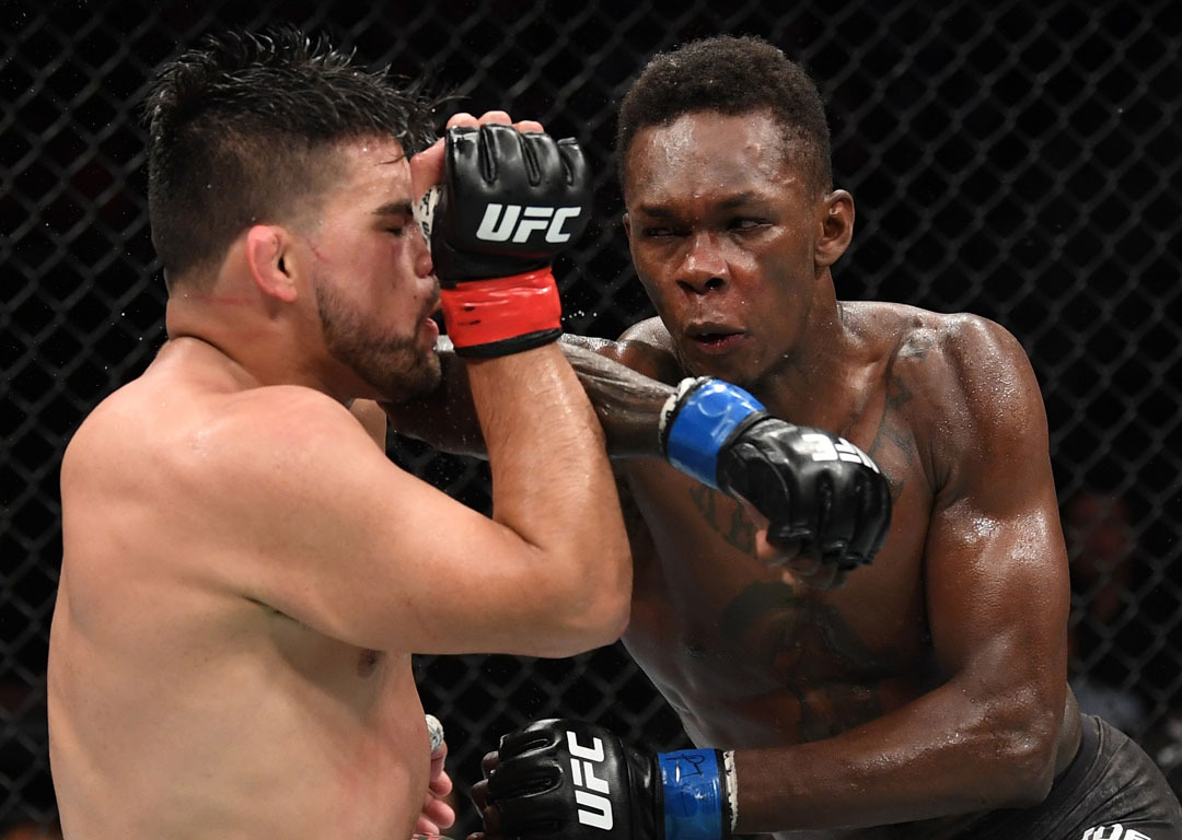 Israel Adesanya elbows Kelvin Gastelum in their interim middleweight championship bout. Photo / Getty
