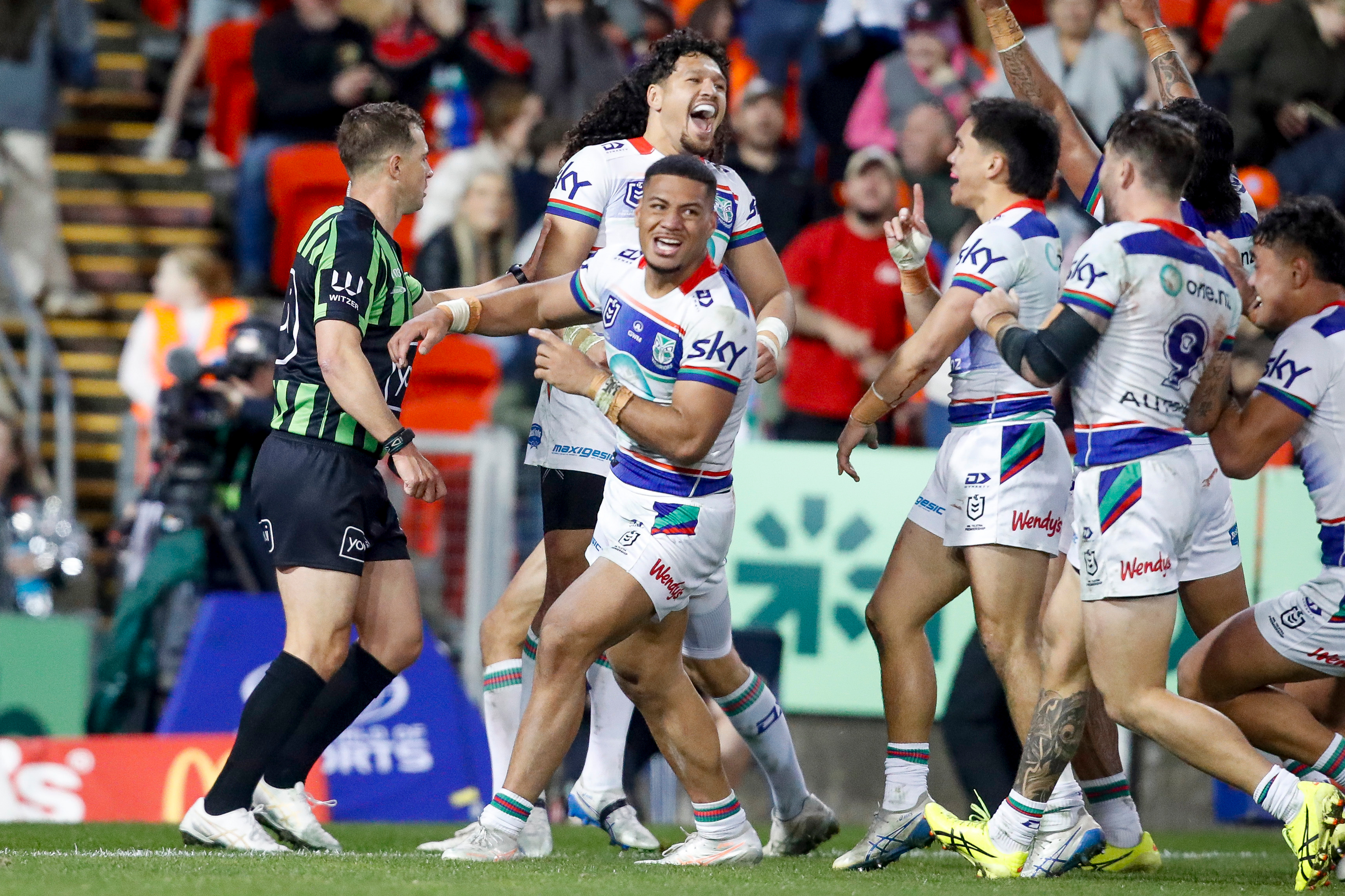 The Warriors celebrate after Leka Halasima scores the game-winning try. Photo / Photosport